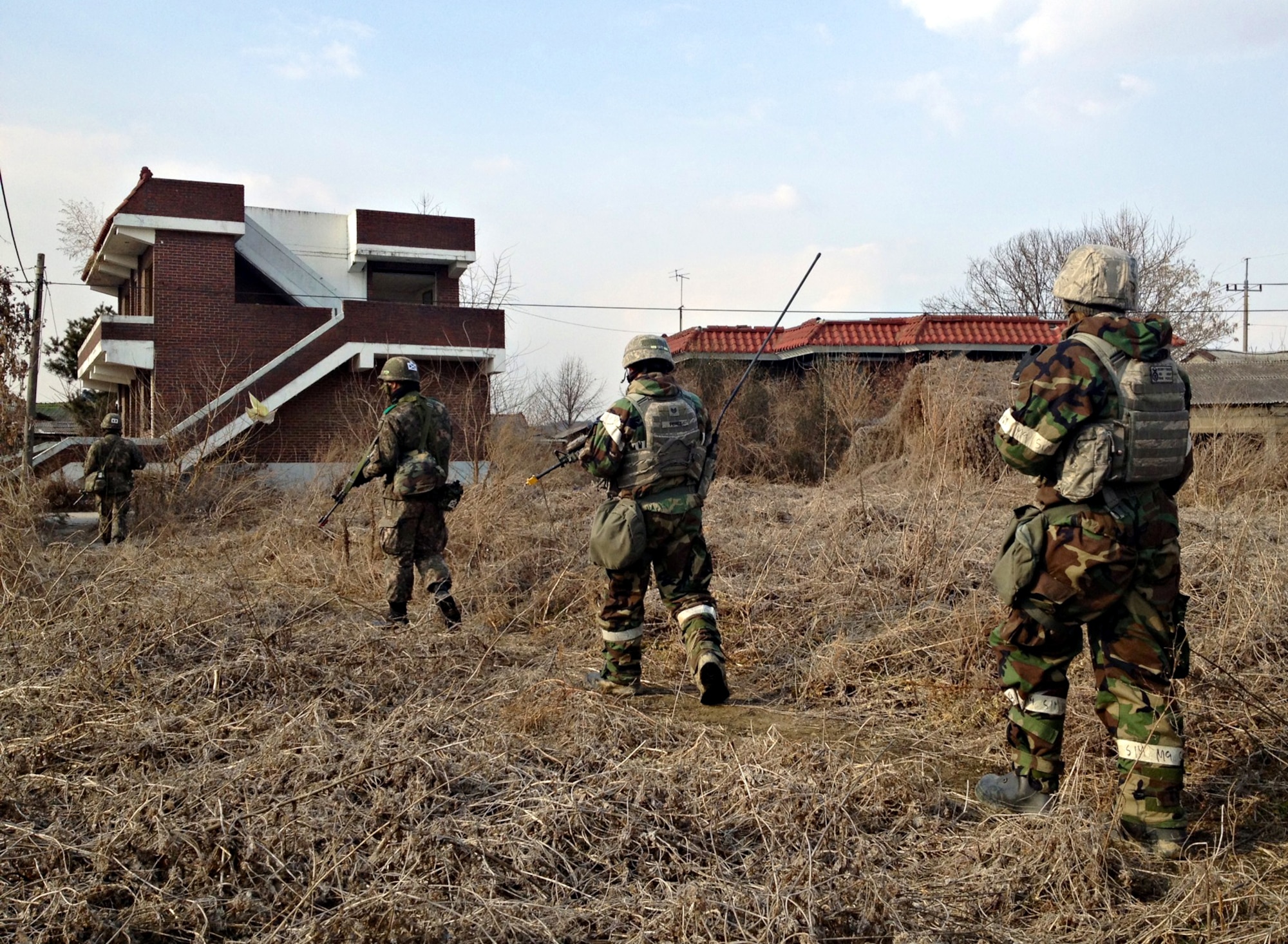 Defenders from the 51st Security Forces Squadron and members of the Republic of Korea army 4th Battalion search for opposition forces role players during a joint mission as part of Operational Readiness Exercise Beverly Midnight 14-02 in a training area outside Osan Air Base, ROK, Feb. 12, 2014. In a real-world operation, the 51st SFS would be responsible for securing the immediate area around the base to help keep the 51st Fighter Wing’s mission up and running. (U.S. Air Force courtesy photo/1st Lt. Tate Grogan)