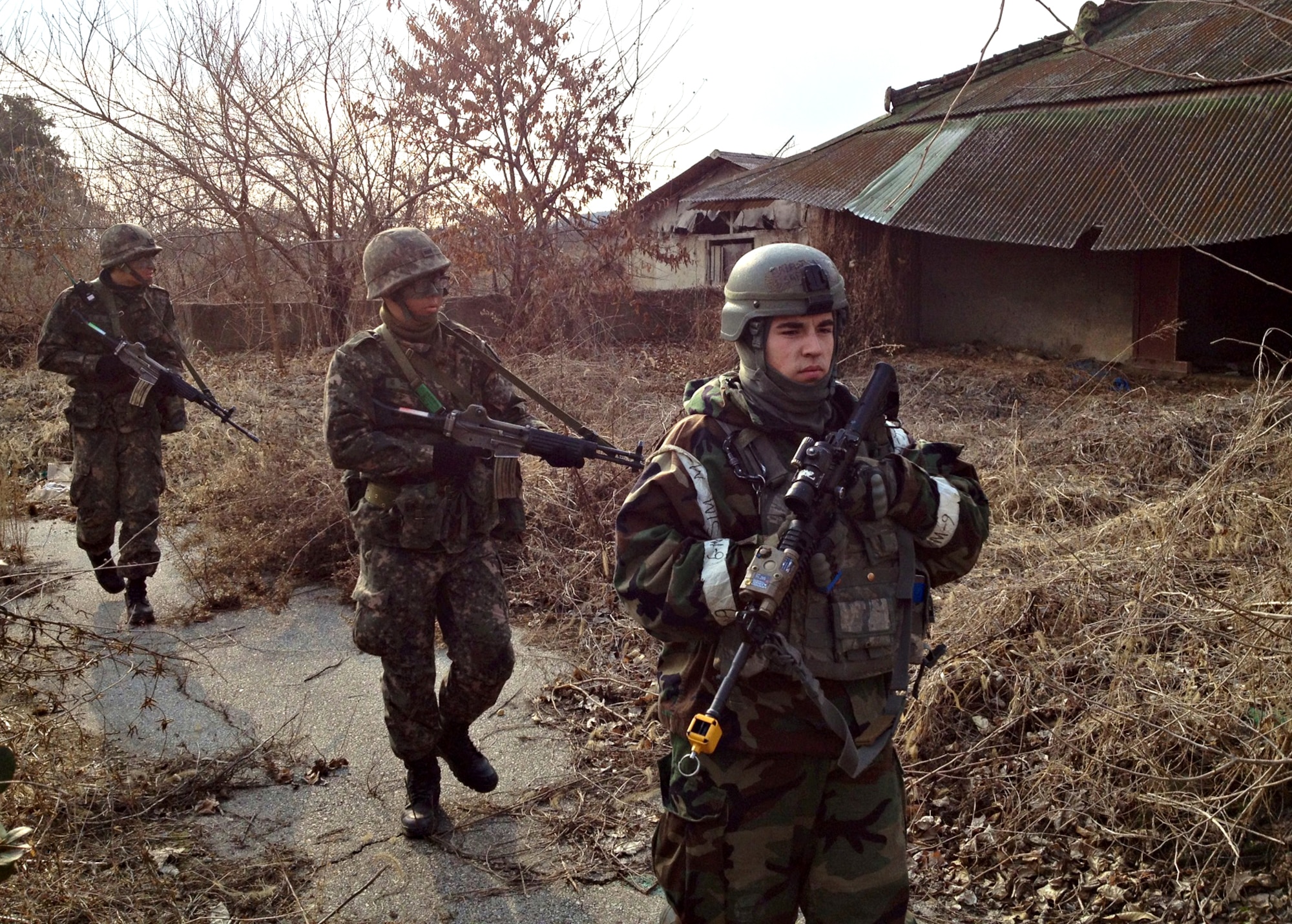 A defender from the 51st Security Forces Squadron leads a patrol with members of the Republic of Korea army 4th Battalion during a joint mission as part of Operational Readiness Exercise Beverly Midnight 14-02 in a training area outside Osan Air Base, ROK, Feb. 12, 2014. The 51st SFS and the ROKA train together to enhance cooperation and ensure integration between the services is as smooth as possible during wartime contingency operations. (U.S. Air Force courtesy photo/1st Lt. Tate Grogan)