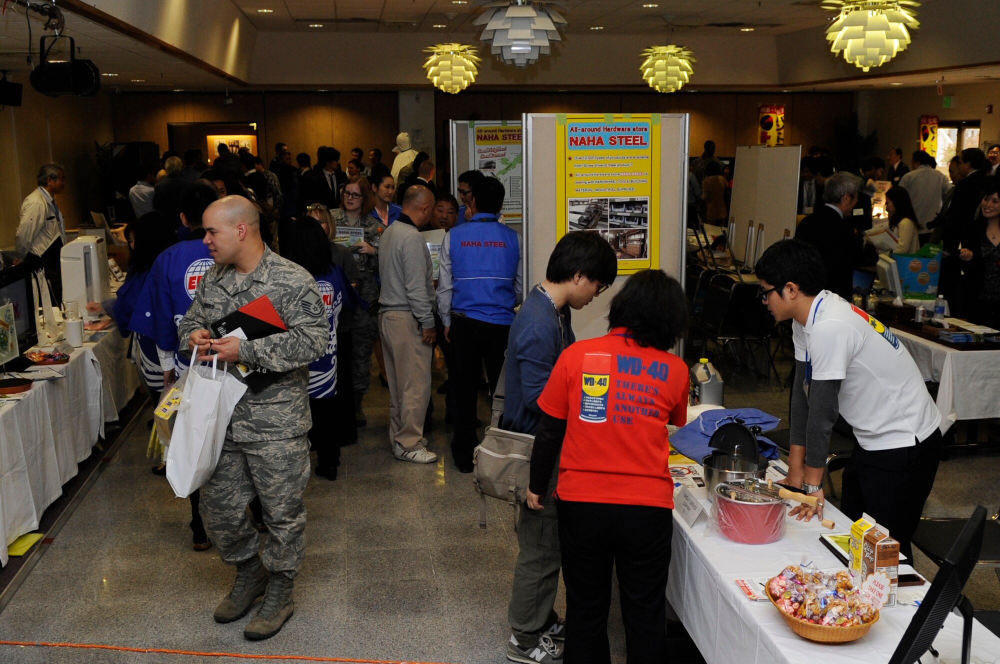 Government Purchase Card holders, unit resource advisors and military members meet local Okinawan companies during the fourth annual Okinawan First Vendor Showcase on Kadena Air Base, Japan, Feb. 6, 2014. More than 20 local vendors came to the event, displaying products including insulated brick, recycled toner cartridges, cargo services, and the ability to repair heating, ventilation and air conditioning systems. (U.S. Air Force photo by Senior Airman Marcus Morris)