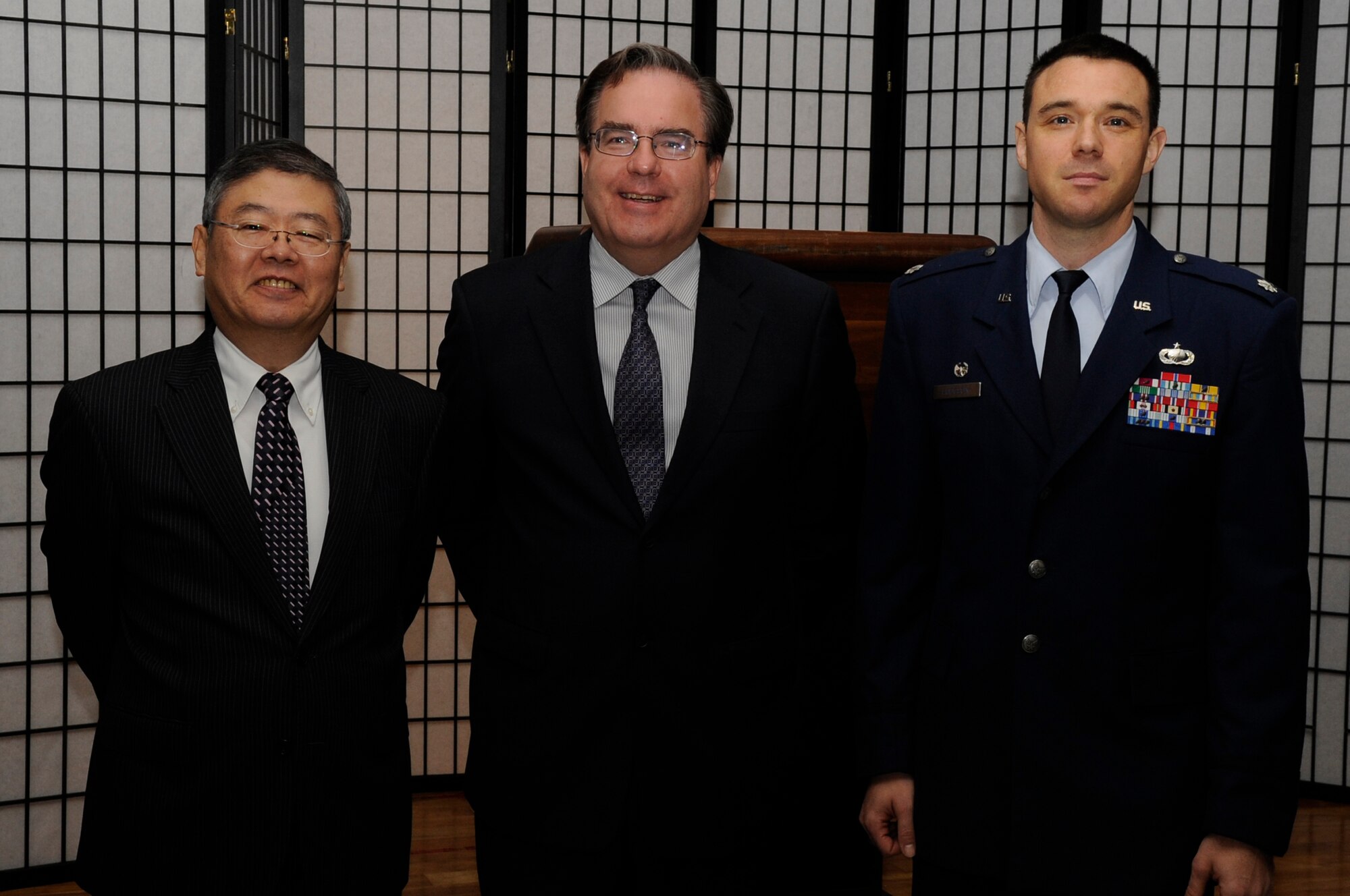 Katsunori Uehara, Okinawa Industry Promotion Public Cooperation chief operating officer, Alfred Magleby, American Consulate general, and Lt. Col. Calvin Hodgson, 18th Contracting Squadron commander, pose for a photo during the opening of the fourth annual Okinawan First Vendor Showcase on Kadena Air Base, Japan, Feb. 6, 2014. More than 20 local vendors came to the event, displaying products including insulated brick, recycled toner cartridges, cargo services, and the ability to repair heating, ventilation and air conditioning systems. (U.S. Air Force photo by Senior Airman Marcus Morris)