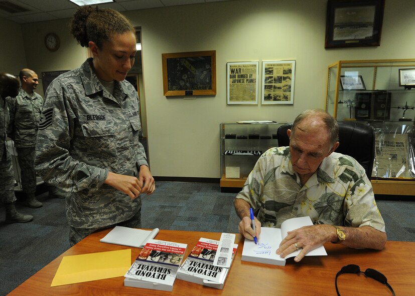 Tech. Sgt. Leeann Bledsoe, 15th Wing Professional Military Education instructor, receives an autographed book “Beyond Survival” by U.S. Navy Capt. (retired) Jerry Coffee, former Vietnam prisoner of war, book during a speaking engagement at the Binnicker PME Center on Joint Base Pearl Harbor-Hickam, Hawaii, Feb. 11, 2014. Coffee was among the 591 POWs returned home between Feb. 12 and April 1, 1974, after the U.S. and the Democratic Republic of Vietnam signed a peace treaty which ended the Vietnam War. (U.S. Air Force photo/Master Sgt. Jerome S. Tayborn)