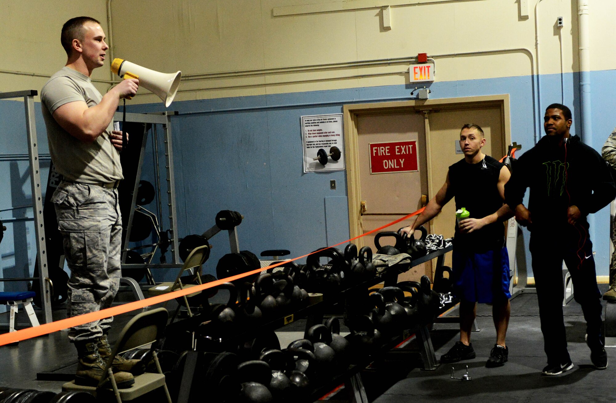 Senior Airman Andy Belo, 366th Force Support Squadron fitness apprentice, introduces the series of events during the Strongman Competition on Mountain Home Air Force Base, Idaho, Feb. 6, 2014. The three events consisted of bench presses, shoulder presses, front squats and as a tie breaker, wall ball tosses. (U.S. Air Force photo by Senior Airman Caitlin Guinazu/RELEASED)
