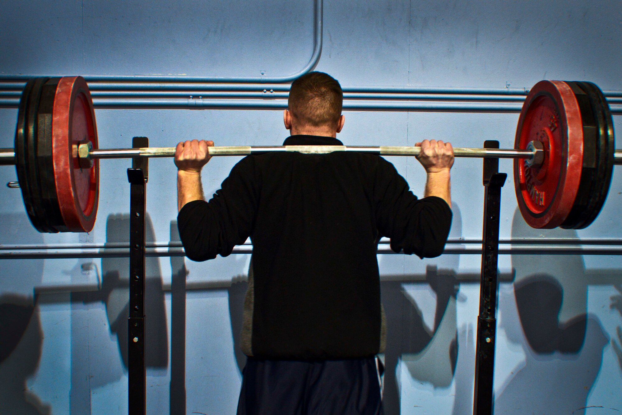 Senior Airman Abraham Fish, 366th Component Maintnance Squadron avianics backshop journeyman, shoulder presses during the Strongman Compitition on Mountain Home Air Force Base, Idaho, Feb. 6, 2014. The competition consisted of three grueling events, with the winners of each weight class contunuing on to the final ‘burnout’. (U.S. Air Force illistration by Senior Airman Caitlin Guinazu/RELEASED)