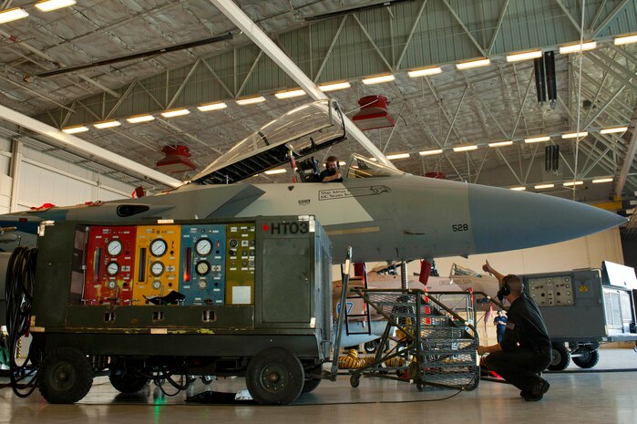 U.S. Air Force Senior Airman Daniel Yager, 757th Aircraft Maintenance Squadron Aircraft Cannibalization Dock technician (left), and Staff Sgt. Adrian Navarro, 757th AMXS Cannibalization Dock manager (right), conduct an aircraft hydraulic test on an F-15C Eagle Feb. 10, 2014, inside the Flanker aircraft maintenance unit hangar at Nellis Air Force Base, Nev. The hydraulic system is tested using a hydraulic mule, ensuring the aircrafts hydraulics are running correctly. (U.S. Air Force photo by Airman 1st Class Timothy Young)