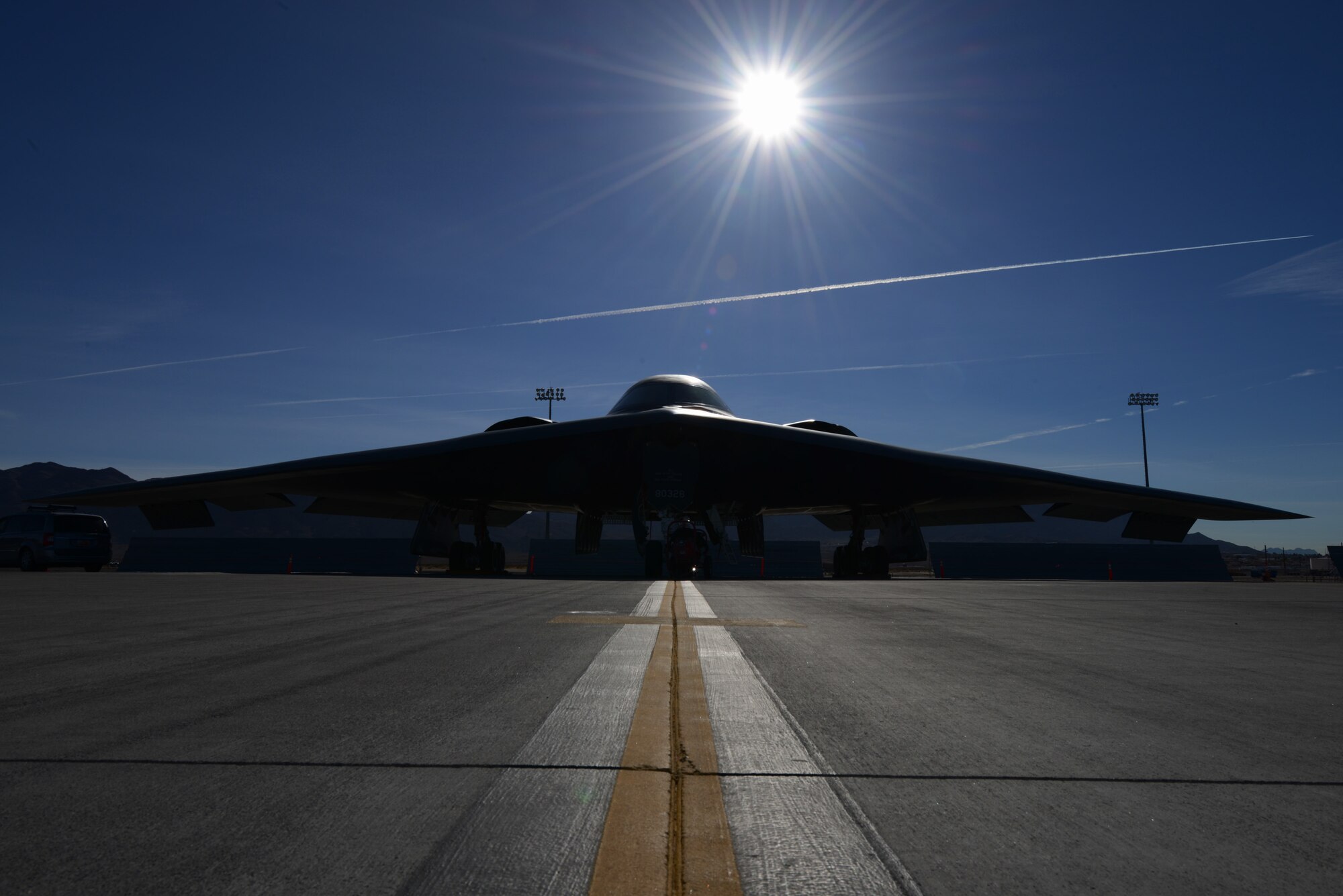 A B-2 Spirit from the 13th Bomb Squadron, Whiteman Air Force Base, Mo., sits on the flightline Feb. 11, 2014, at Nellis AFB, Nev. The 13th BS is at Nellis AFB to participate in the premier combat exercise Red Flag 14-1 Jan. 27 to Feb. 14. During Red Flag training missions, the B-2 Spirit aircrews practice infiltrating contested enemy airspace and destroying high value targets.  By providing realistic combat training in a contested, degraded and operationally limited environment, Red Flag 14-1 provides pilots with real-time war scenarios and helps ground crews test their readiness capabilities. (U.S. Air Force photo by Senior Airman Benjamin Sutton/Released) 