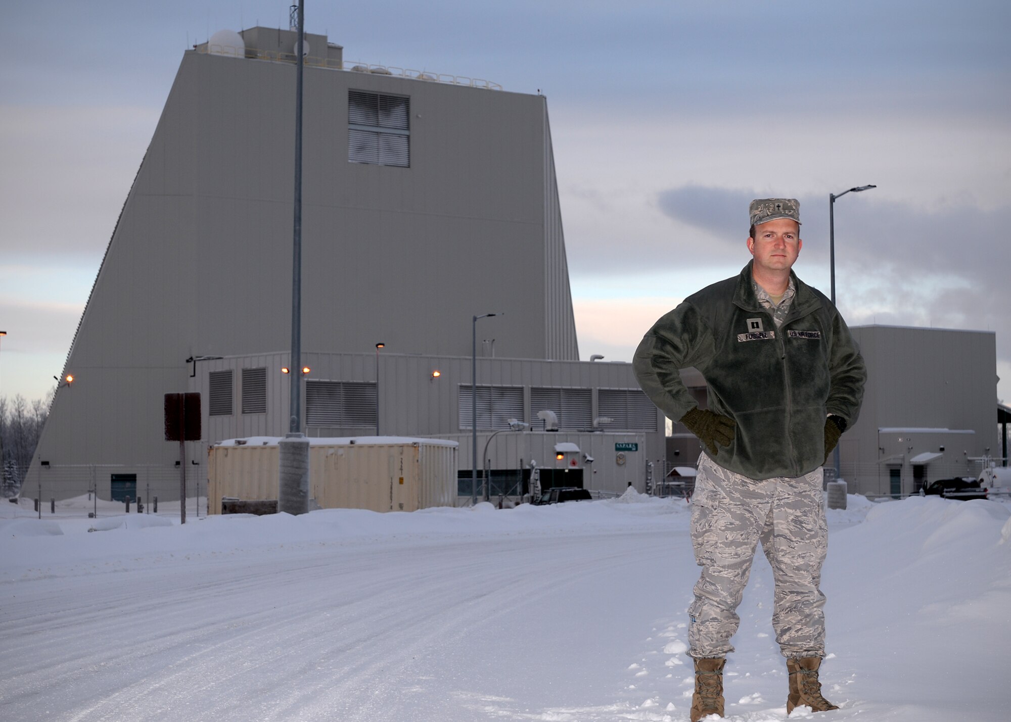 Chaplain (Capt.) Thomas Fussell, 354th Fighter Wing protestant chaplain, stands in front of the phased array radar at Clear Air Station, Alaska, Feb. 6, 2014. Chaplains from Eielson Air Force Base and Joint Base Elmendorf Richardson, Alaska, travel the icy roads to the remote radar station every other week to aid the aid the Airmen there in completing the mission of providing early warning of intercontinental ballistic missiles and submarine-launched ballistic missiles. (U.S. Air Force photo by Senior Airman Shawn Nickel/Released)