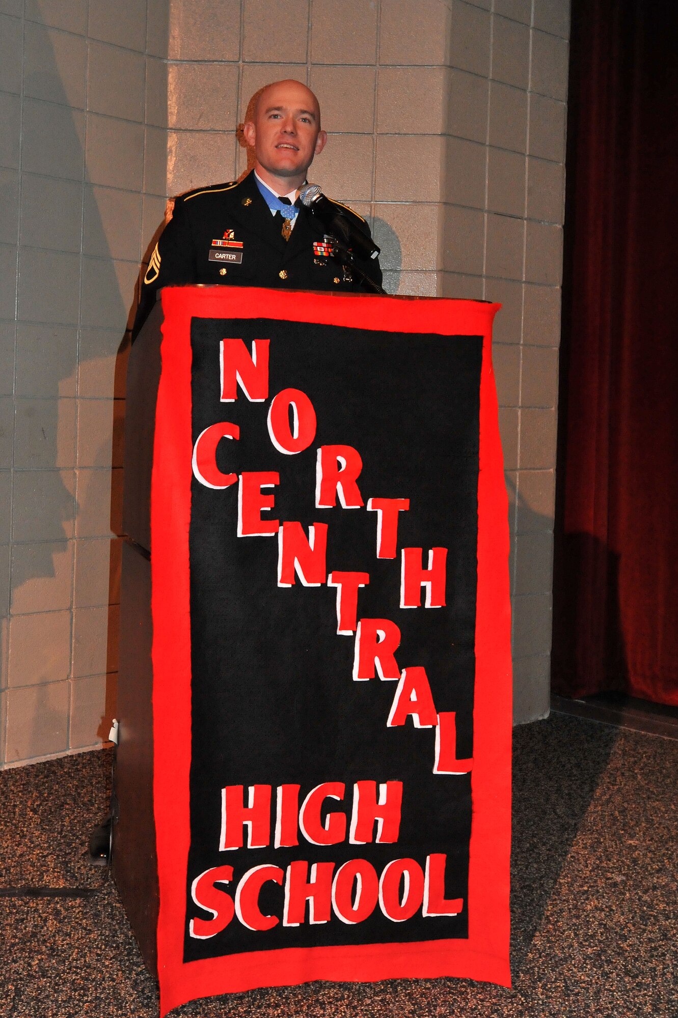 U.S. Army Staff Sgt. Ty Carter, talks to students while he was recognized as this year’s distinguished alumnus Feb. 7, 2014, during the annual Red and Black Convocation at North Central High School in Spokane, Wash. Carter, a graduate of the high school from the class of 1998, received the Medal of Honor from President Barack Obama at the White House in August 2013, for his valor and actions on the battle field in Afghanistan. (U.S. Air Force photo by Staff Sgt. Veronica Montes/Released)
