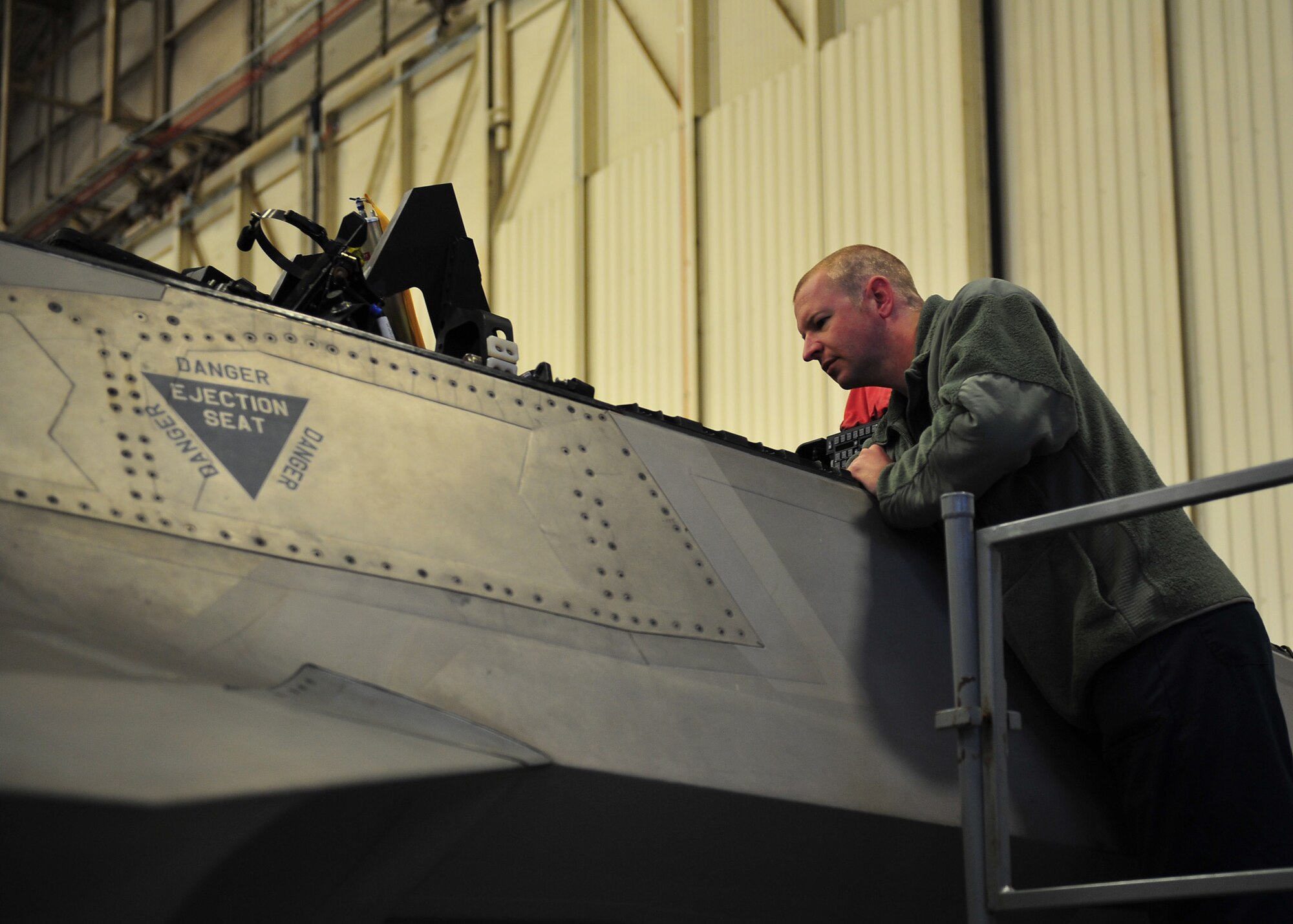 Staff Sgt. Michael Cantrell, 95th Air Maintenance Unit dedicated crew chief, inspects various ejection and pilot safety components in the cockpit of an F-22 Raptor, Jan. 15 in Hangar 1. Tyndall recently gained several combat ready F-22 Raptors from Holloman Air Force Base, N.M. Those jets must undergo an acceptance process in order to call Tyndall their home. (U.S. Air Force photo by Airman 1st Class Dustin Mullen)