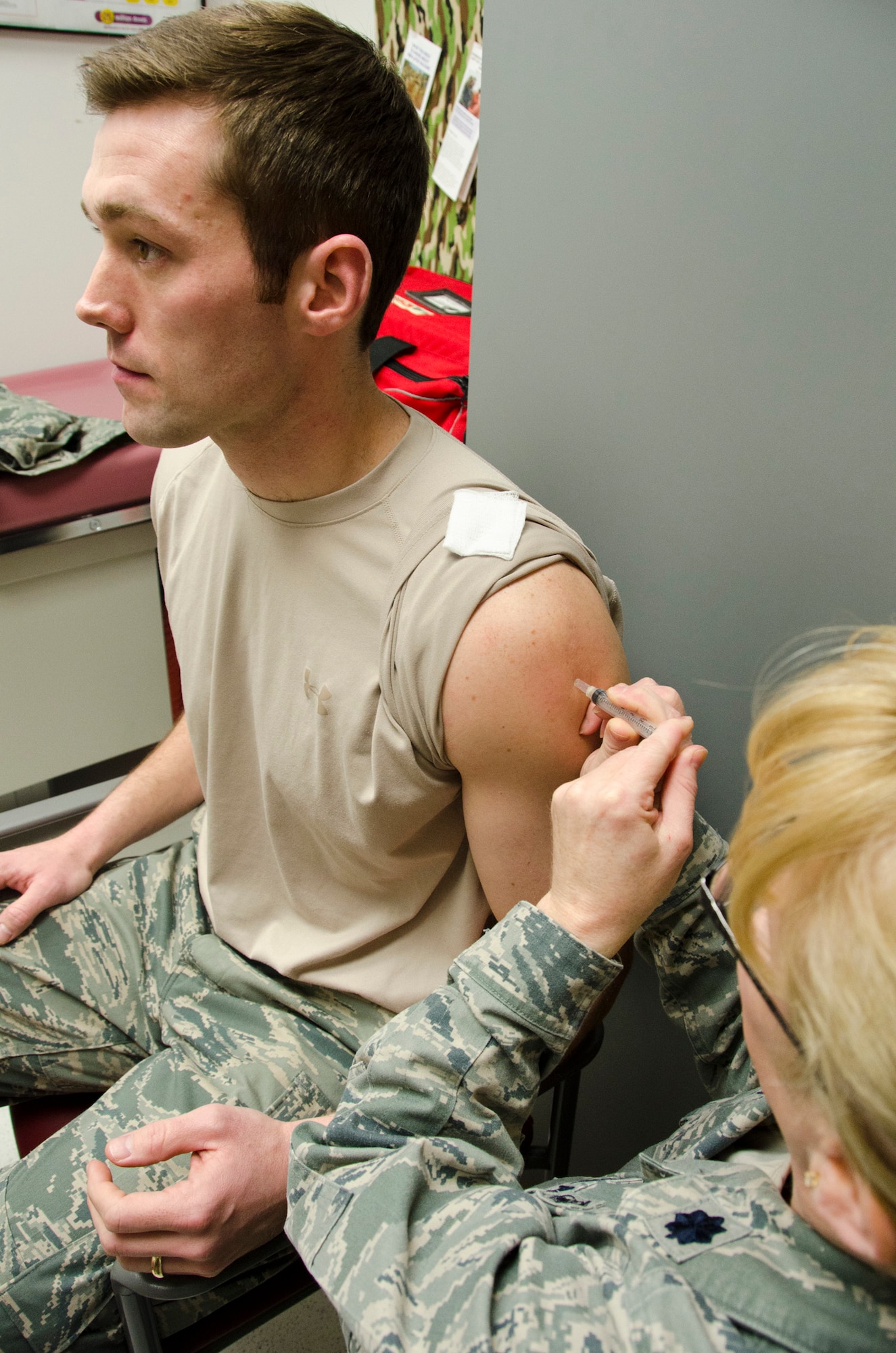 An Airman of the 131st Bomb Wing, Missouri Air National Guard, receives his annual flu shot from Lt. Col. Susan Walker, chief nurse executive for the 131st Medical Group.  Flu season has not peaked yet and typically lasts until May, making it vitally important to get vaccinated.(U.S. Air National Guard Photo by Airman Halley Burgess/RELEASED)