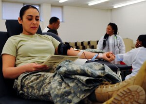 U.S. Army Spc. Nori Garcia, 7th Transportation Brigade (Expeditionary), 11th Transportation Btn., 331st Transportation Company watercraft operator, donates blood to the American Red Cross at Fort Eustis, Va., Feb. 12, 2014. According to the ARC, approximately one person every second in the U.S. needs blood due to traumatic injury treatments, surgeries and other medical procedures. (U.S. Air Force photo by Airman 1st Class Austin Harvill/Released)