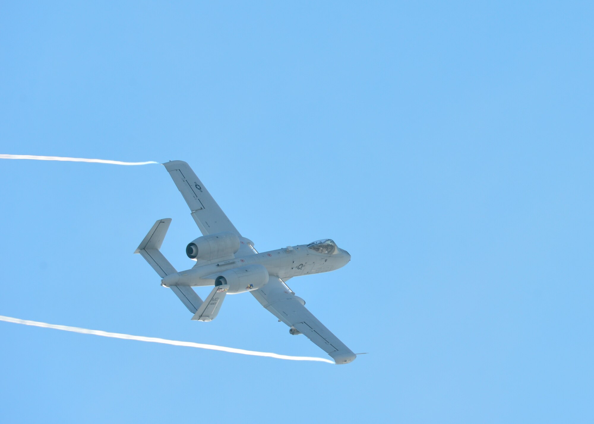 An A-10C Thunderbolt II leaves vapor trails as it flies overhead Feb. 6, 2014, at the Bollen Live-Fire Range Complex on Fort Indiantown Gap, Pa. The A-10C Thunderbolt II conducted live fire training along with a C-17A Globemaster III from Dover Air Force Base, Del., and joint terminal air controllers from the 11th Air Support Operations Squadron at Fort Hood, Texas. (U.S. Air Force photo/Airman 1st Class William Johnson)
