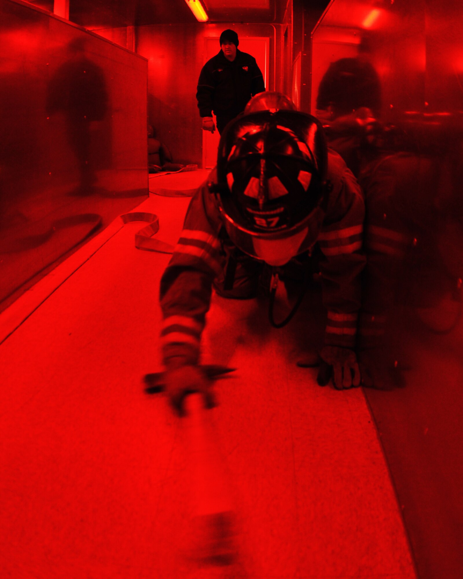 GOODFELLOW AIR FORCE BASE, Texas – Steven Gassiot, San Angelo Fire Department recruit, uses an axe to feel his way around, while blindfolded, inside the search and rescue trainer at the Louis F. Garland DoD Fire Academy here Feb. 6. SAFD and Goodfellow students use their firefighting tools to feel around corners, objects and drop-offs. (U.S. Air Force photo/ Senior Airman Joshua Edwards)