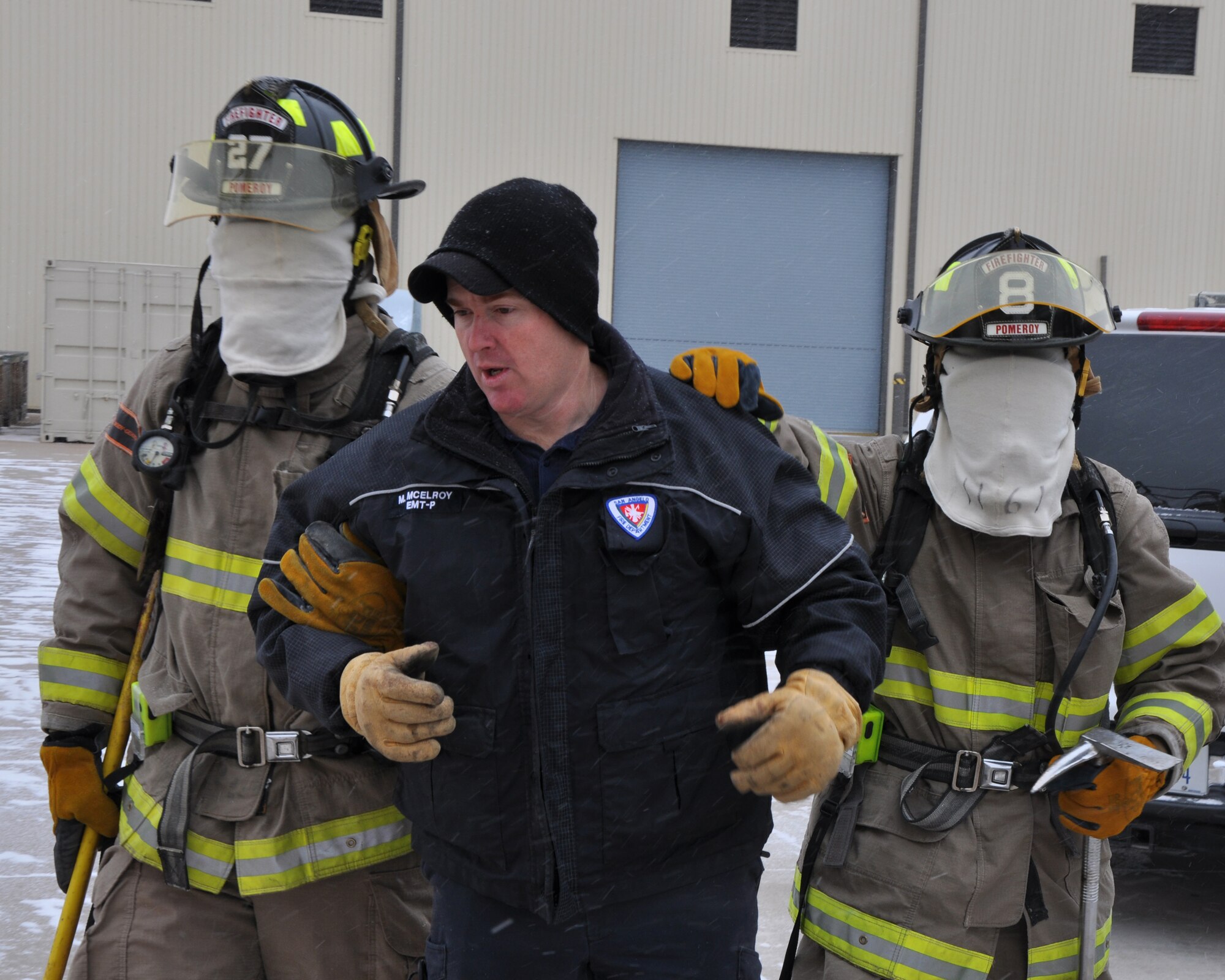 GOODFELLOW AIR FORCE BASE, Texas – Lt. Mac McElroy, San Angelo Fire Department rescue officer, leads two blindfolded SAFD recruits to the entrance of the search and rescue trainer at the Louis F. Garland DoD Fire Academy here Feb. 6. SAFD and Goodfellow use this simulator to check if students remember to mark doors, test to see if a door is hot and how well they can navigate without being able to see. (U.S. Air Force photo/ Senior Airman Joshua Edwards)