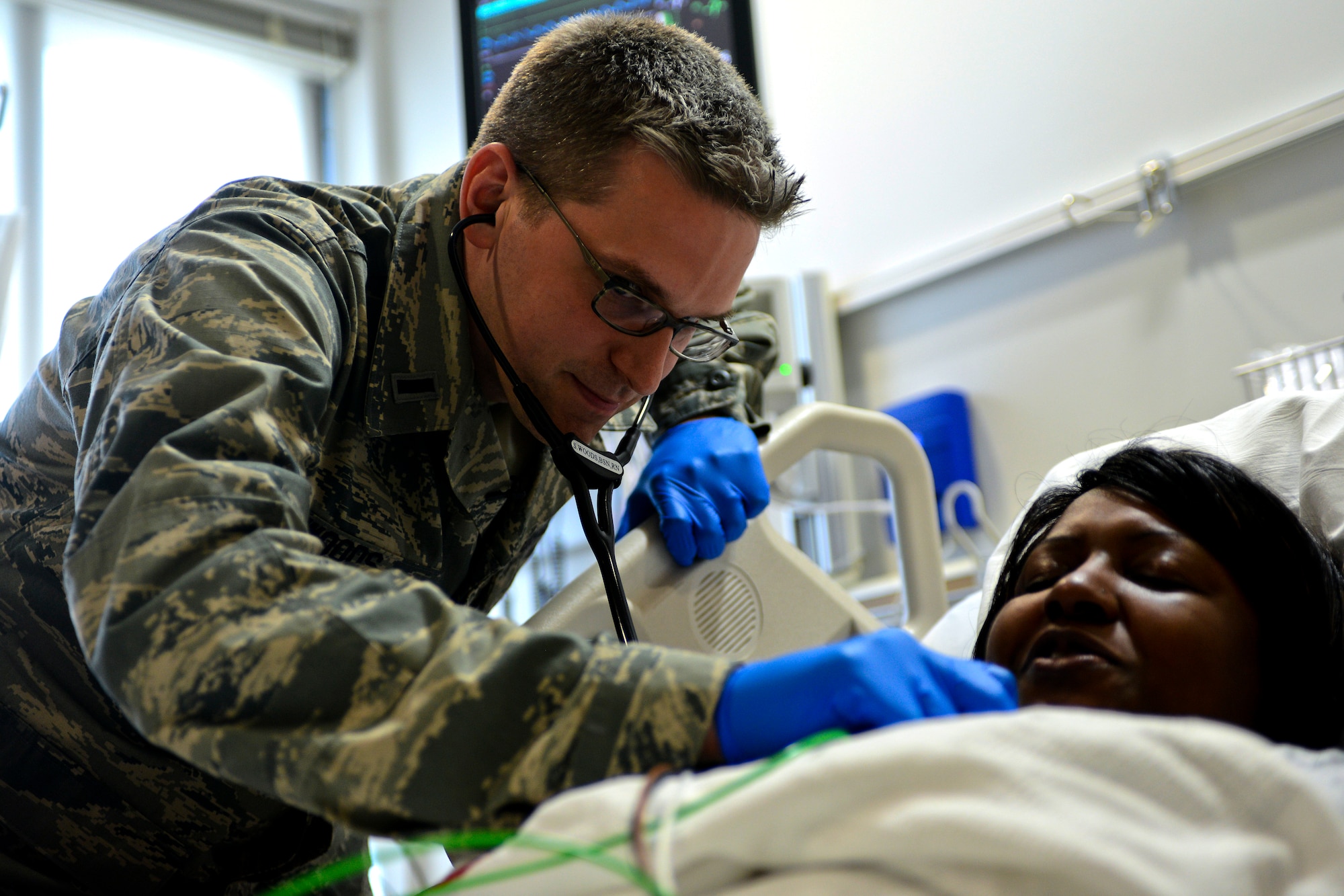 U.S. Air Force 1st Lt. Steven Woods, 633rd Inpatient Operations Squadron clinical nurse, checks the vital signs of Staff Sgt. Portia Les’Pere, 633rd IPTS aerospace medical technician, during a simulation at Langley Air Force Base, Va., June 26, 2013. The Hospital Langley emergency room is scheduled to move to a new location, Feb. 27, which provides a larger space and more beds to accommodate patients. (U.S. Air Force photo by Airman 1st Class R. Alex Durbin/Released)