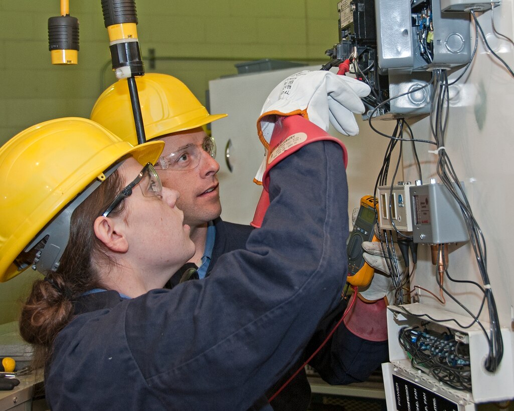 U.S. Air Force Airman Hannah Phillips and Jason Zuccarelli, 366th Training Squadron, HVAC/R Apprentice course are troubleshooting by checking the electrical connections to the HVAC equipment with a multi meter on January 29, 2014 at Sheppard Air Force Base, Texas. (U.S. Air Force photo by Frank Carter/Released)


