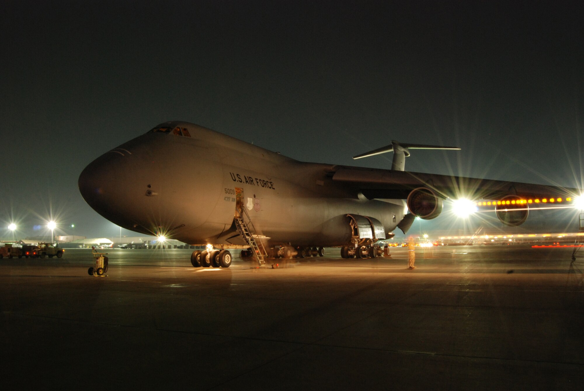 Airmen work around a C-5B Galaxy that arrived at Bagram Airfield, Afghanistan, Feb. 11, 2014. Aerial port Airmen off-loaded multiple pallets of cargo and passengers. (U.S. Air Force photo by Capt. Brian Wagner/Released)