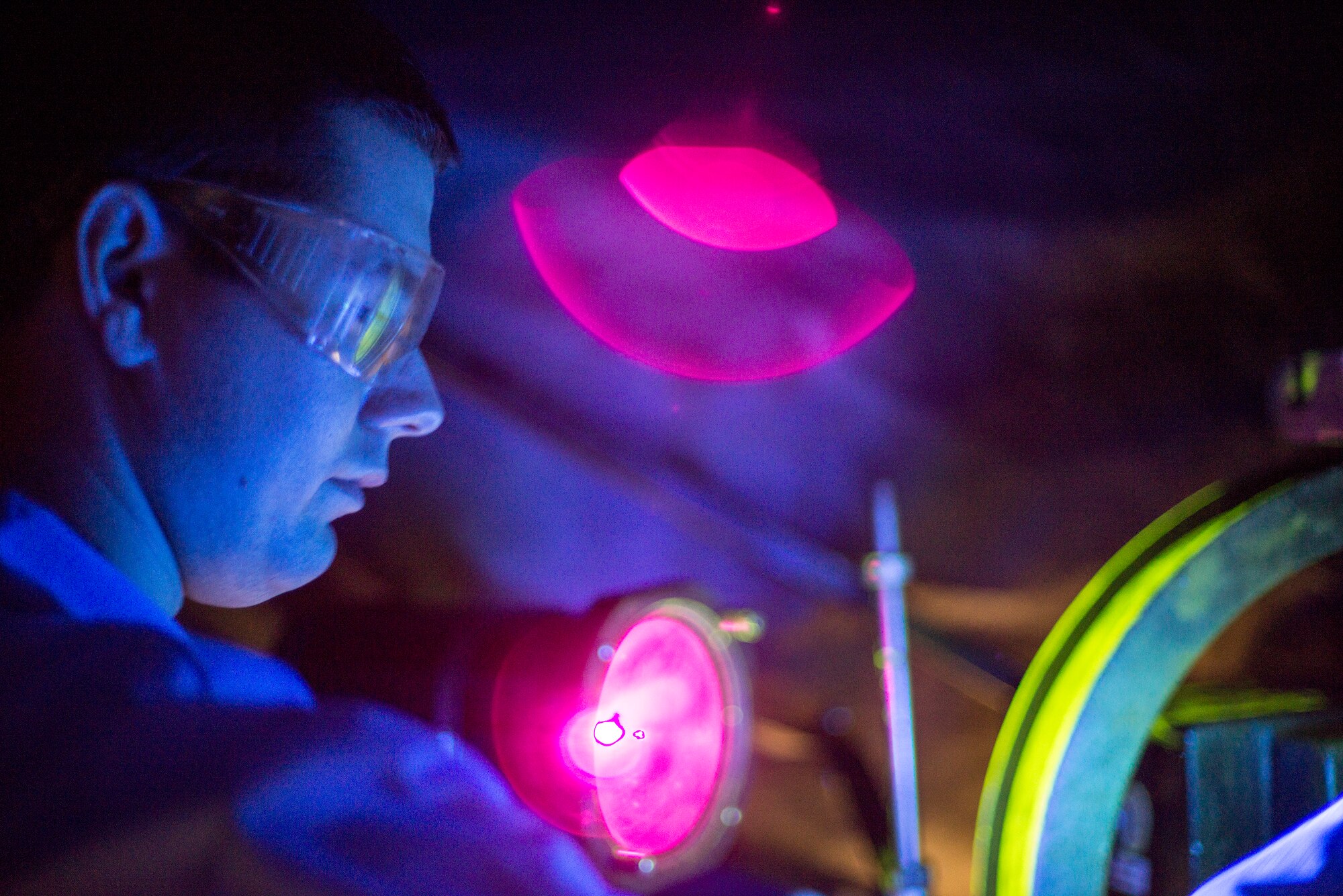 U.S. Air Force Airman Nicholas Burgess, 23d Equipment Maintenance Squadron non-destructive inspection apprentice, uses a magnetic particle unit at Moody Air Force Base, Ga., Feb. 11, 2014. Particles are pulled into crevices and cracks on metal pieces and glow under blacklight to expose weaknesses in aircraft parts. (U.S. Air Force photo by Airman 1st Class Ryan Callaghan/Released)
