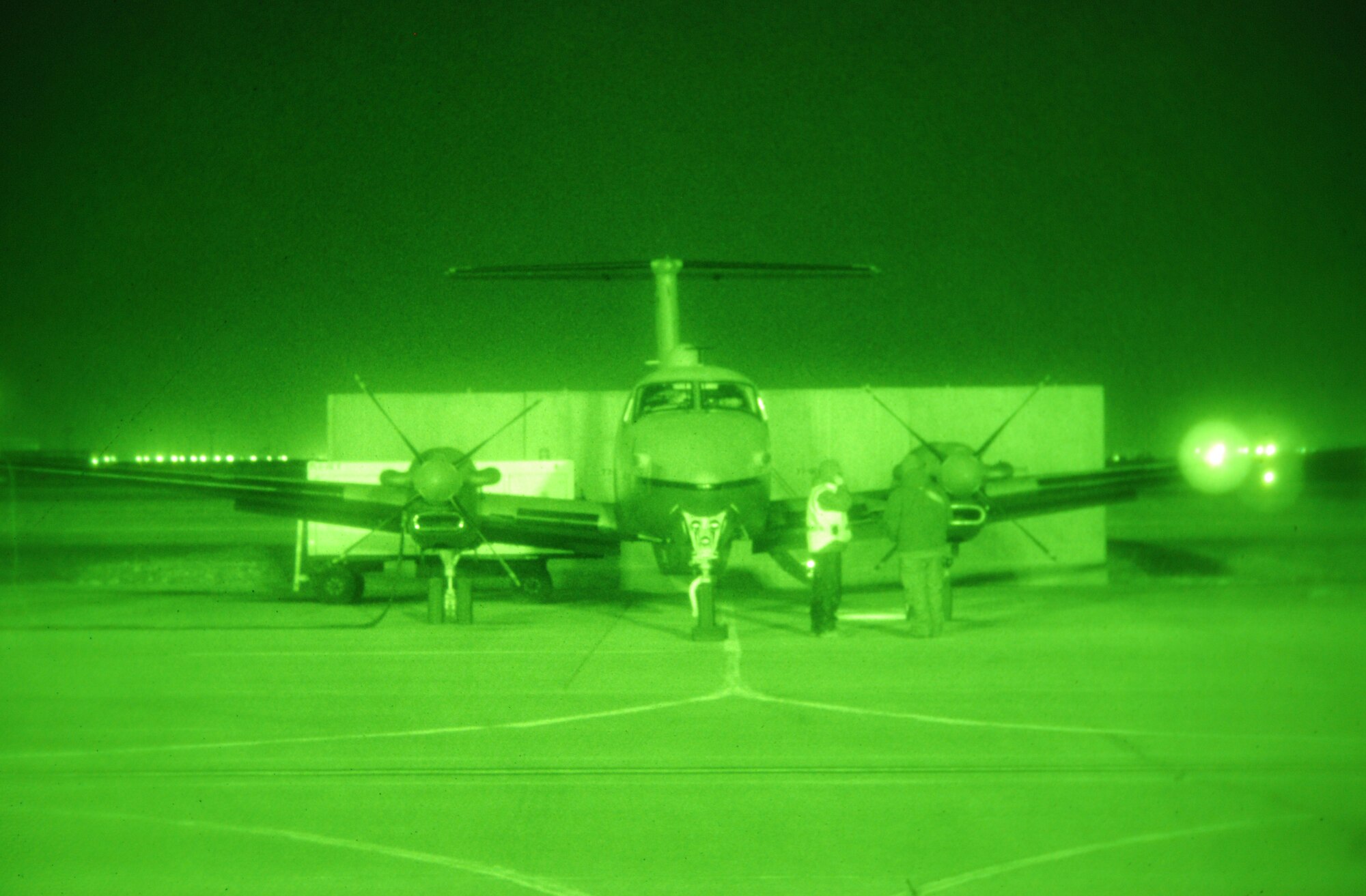Aircrew and ground personnel prepare a MC-12W Liberty for a mission at Bagram Airfield, Afghanistan, Feb. 11, 2014. The MC-12W is vital to intelligence, surveillance and reconnaissance missions throughout Afghanistan. (U.S. Air Force photo by Capt. Brian Wagner/Released)