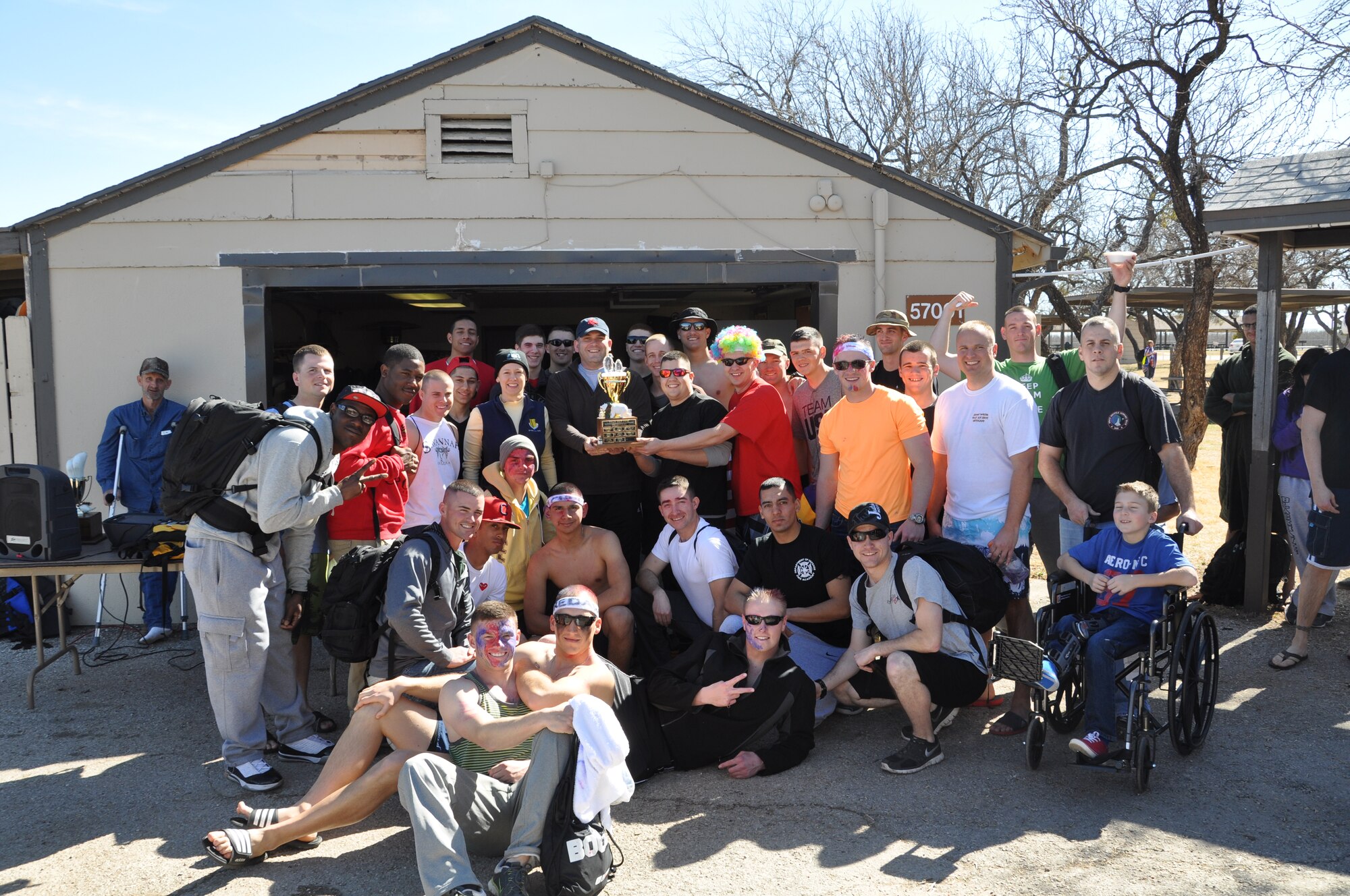 GOODFELLOW AIR FORCE BASE, Texas - Members from the 312th Training Squadron pose with their trophy during the 12th Annual Polar Bear Plunge at the Goodfellow Outdoor Recreation Camp here Feb. 8. The 312th Training Squadron won the large unit award for most participation. (U.S. Air Force photo/ Airman 1st Class Erica Rodriguez)