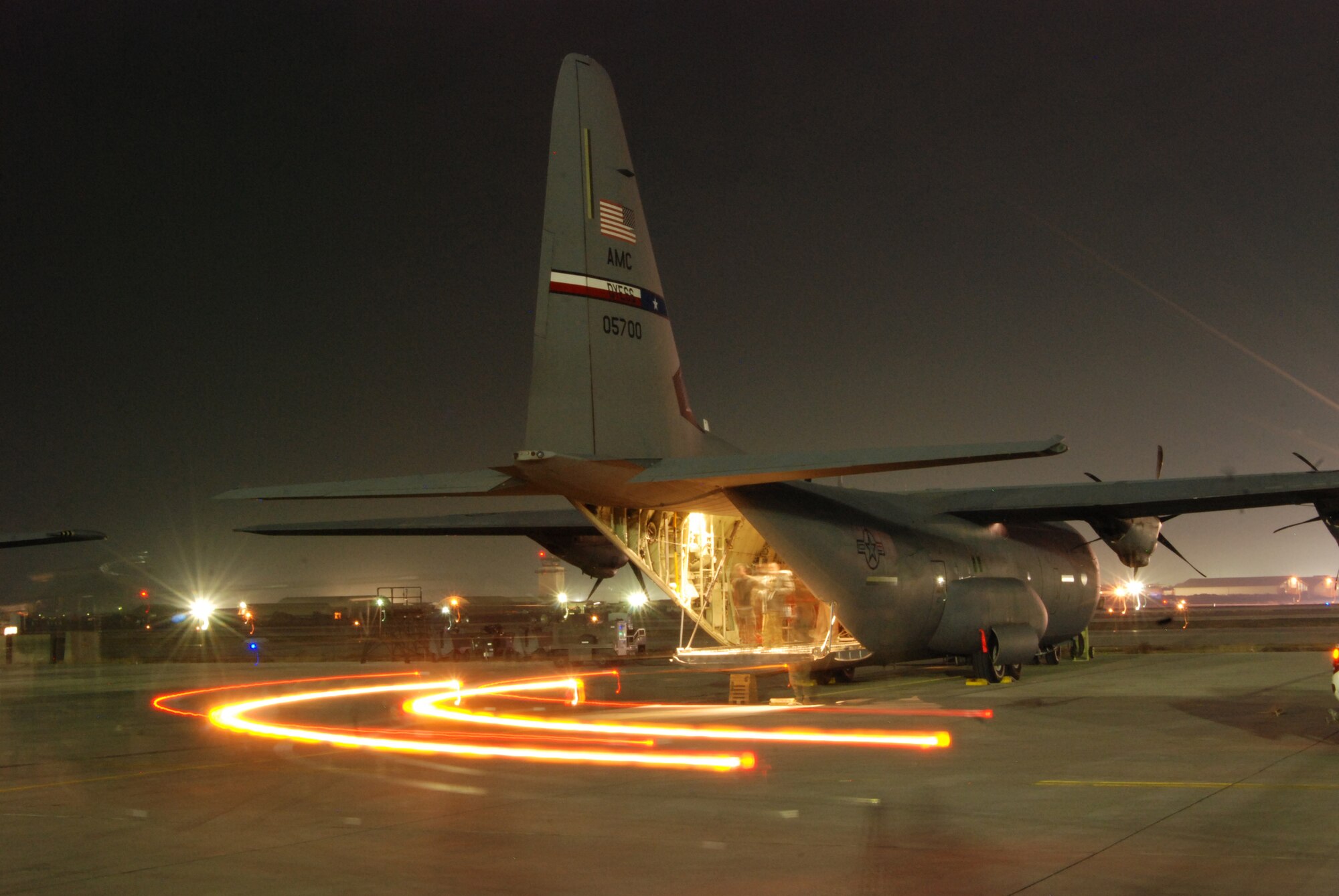 A Halvorsen loader pulls away from a C-130J Super Hercules at Bagram Airfield, Afghanistan, Feb. 11, 2014. Airmen from the aerial port and airlift squadrons support operations 24 hours a day at the Department of Defense’s busiest single runway airfield. (U.S. Air Force photo by Capt. Brian Wagner/Released)