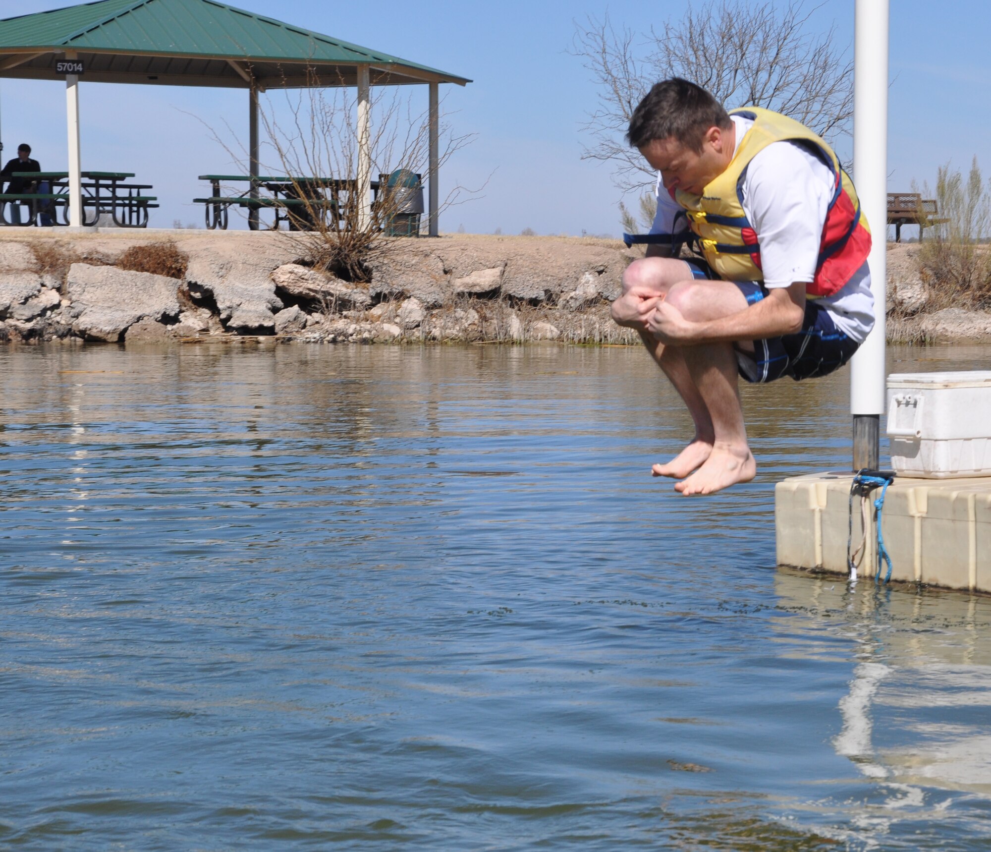 GOODFELLOW AIR FORCE BASE, Texas - Col. Thomas Schmidt, 17th Training Wing Vice Commander, cannonballs into Lake Nasworthy during the 12th Annual Polar Bear Plunge at the Goodfellow Outdoor Recreation Camp Feb. 8.  The wing commander and vice commander were the first to jump during the plunge with 289 other participants. (U.S. Air Force photo/ Airman 1st Class Erica Rodriguez)