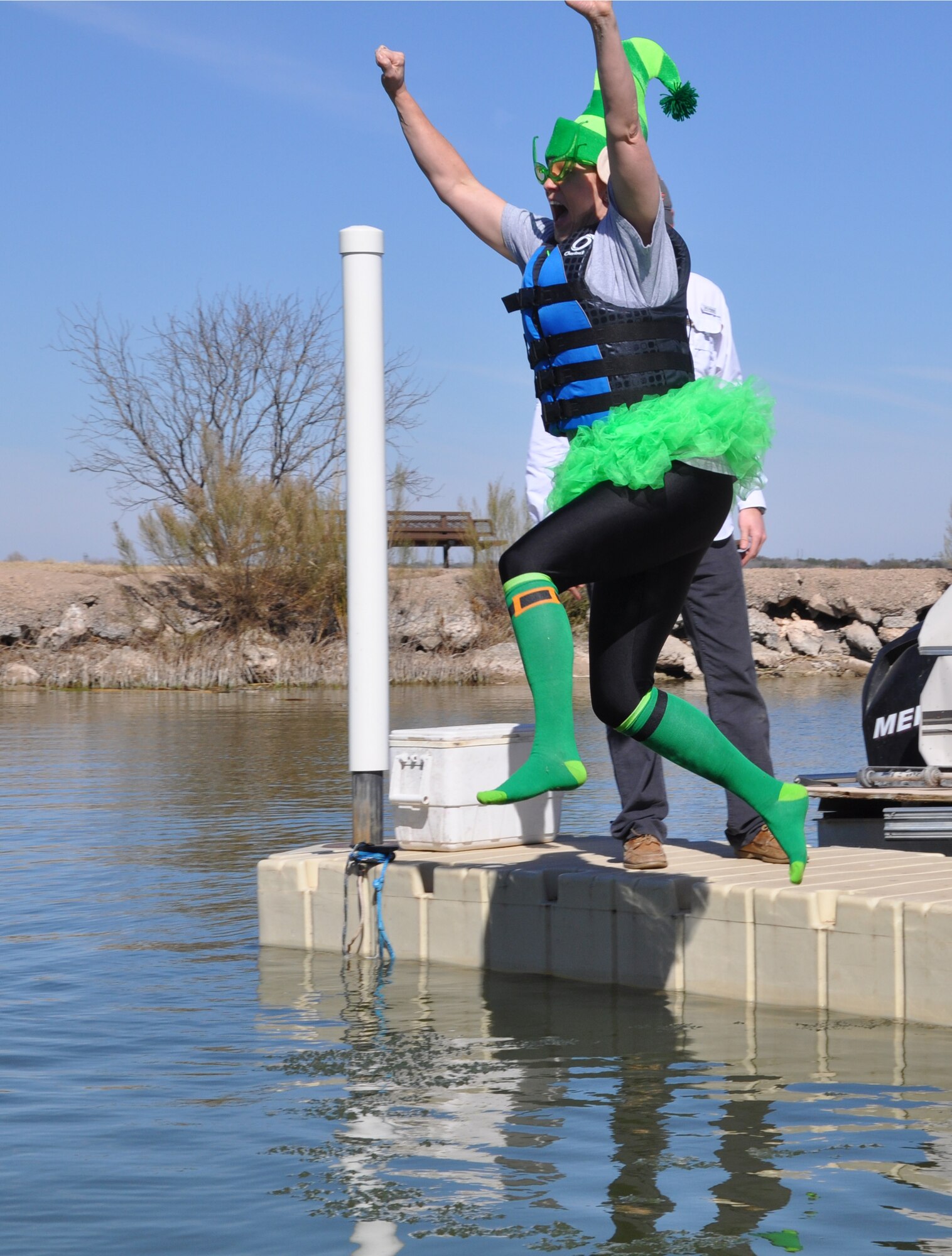 GOODFELLOW AIR FORCE BASE, Texas - Col. Kimberlee Joos, 17th Training Wing Commander, jumps into Lake Nasworthy during the 12th Annual Polar Bear Plunge at the Goodfellow Outdoor Recreation Camp Feb. 8. The plunge is an annual tradition held at Goodfellow to boost morale and camaraderie among members. (U.S. Air Force photo/ Airman 1st Class Erica Rodriguez)