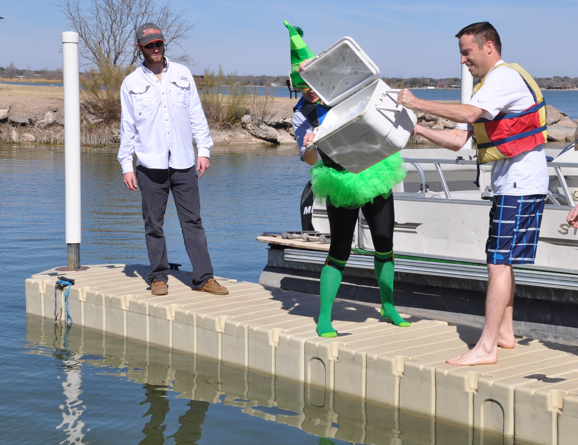 GOODFELLOW AIR FORCE BASE, Texas - Col. Kimberlee Joos, 17th Training Wing Commander, and Col. Thomas Schmidt, 17th TRW Vice Commander, dump a chest of ice into Lake Nasworthy before the 12th Annual Polar Bear Plunge here Feb. 8. The ice dumping is a tradition to start off every Goodfellow polar bear plunge. (U.S. Air Force photo/ Airman 1st Class Erica Rodriguez)