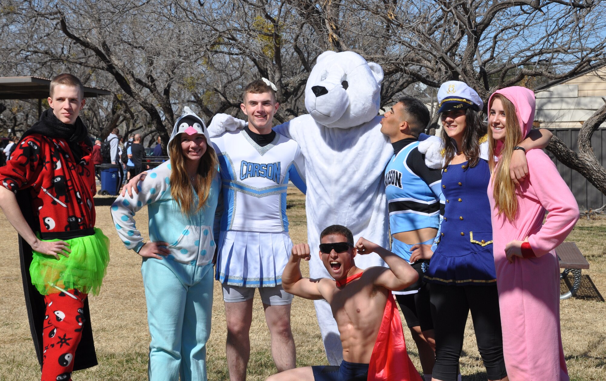 GOODFELLOW AIR FORCE BASE, Texas - 12th Annual Polar Bear Plunge participants pose for a picture with the polar bear mascot at the Goodfellow Outdoor Recreation Camp here Feb. 8. Tradition calls for Polar Bear plungers to dress in costume to compete for Best Costume award. (U.S. Air Force photo/ Airman 1st Class Erica Rodriguez)