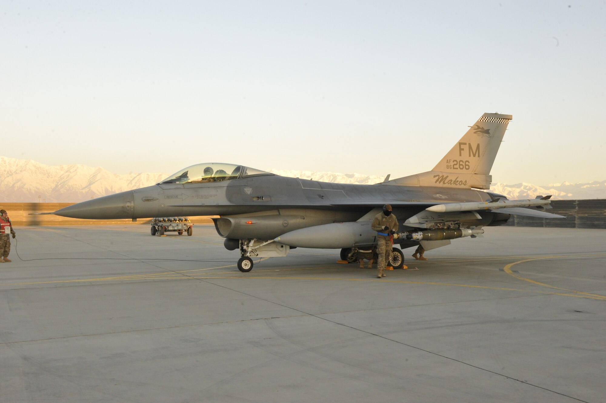 A U.S. Air Force F-16 Fighting Falcon receives a final check before taking off on a mission shortly after dawn from Bagram Airfield, Afghanistan, Feb. 11, 2014. The aircraft and crews at Bagram are prepared to fly 24 hours a day.(U.S. Air Force photo by Senior Master Sgt. Gary J. Rihn/Released)