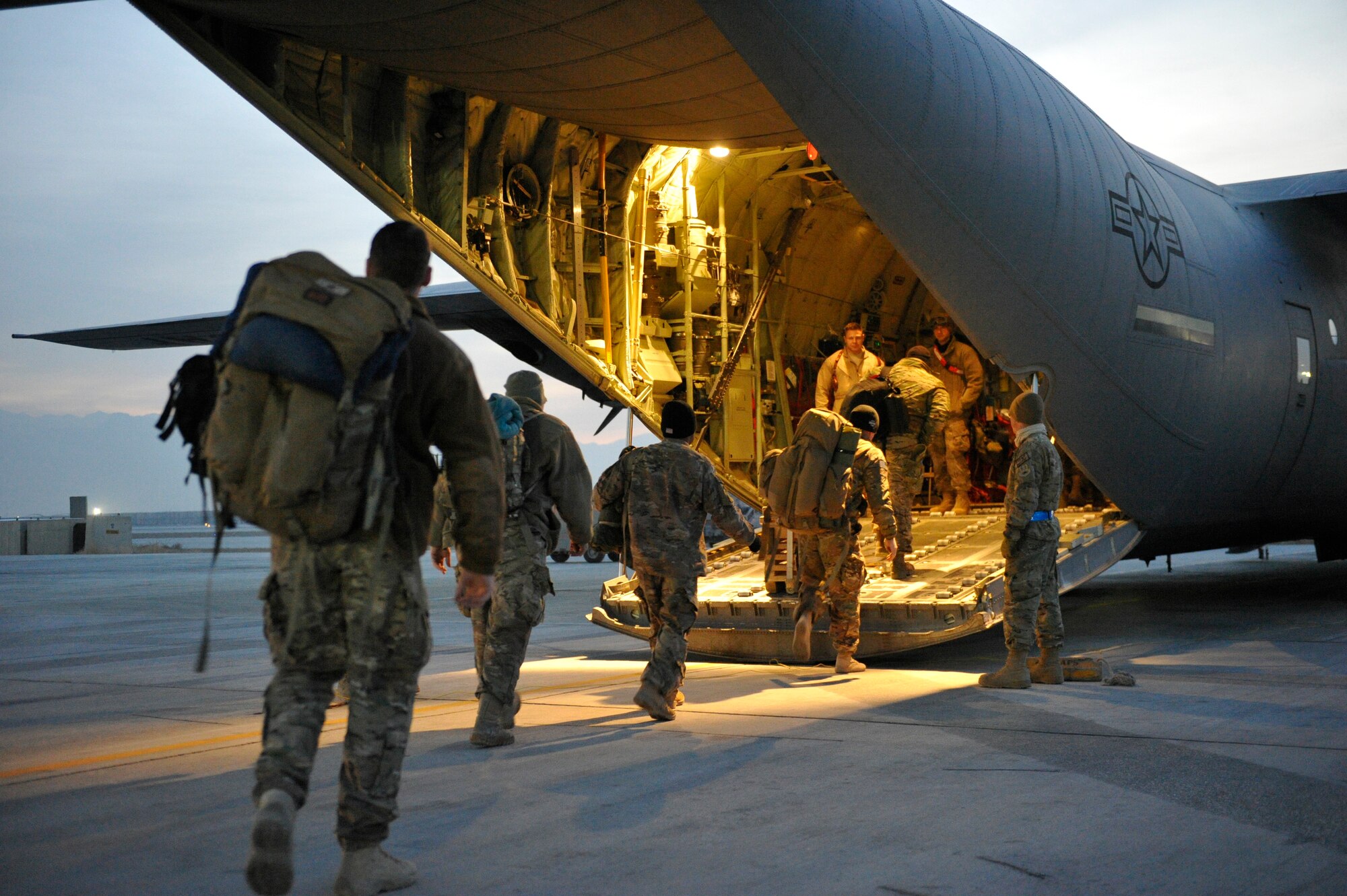 U.S. Service members board a C-130J at dawn at Bagram Airfield, Afghanistan, Feb. 10, 2013. They were on their way to the Transit Center at Manas.(U.S. Air Force photo by Senior Master Sgt. Gary J. Rihn/Released)