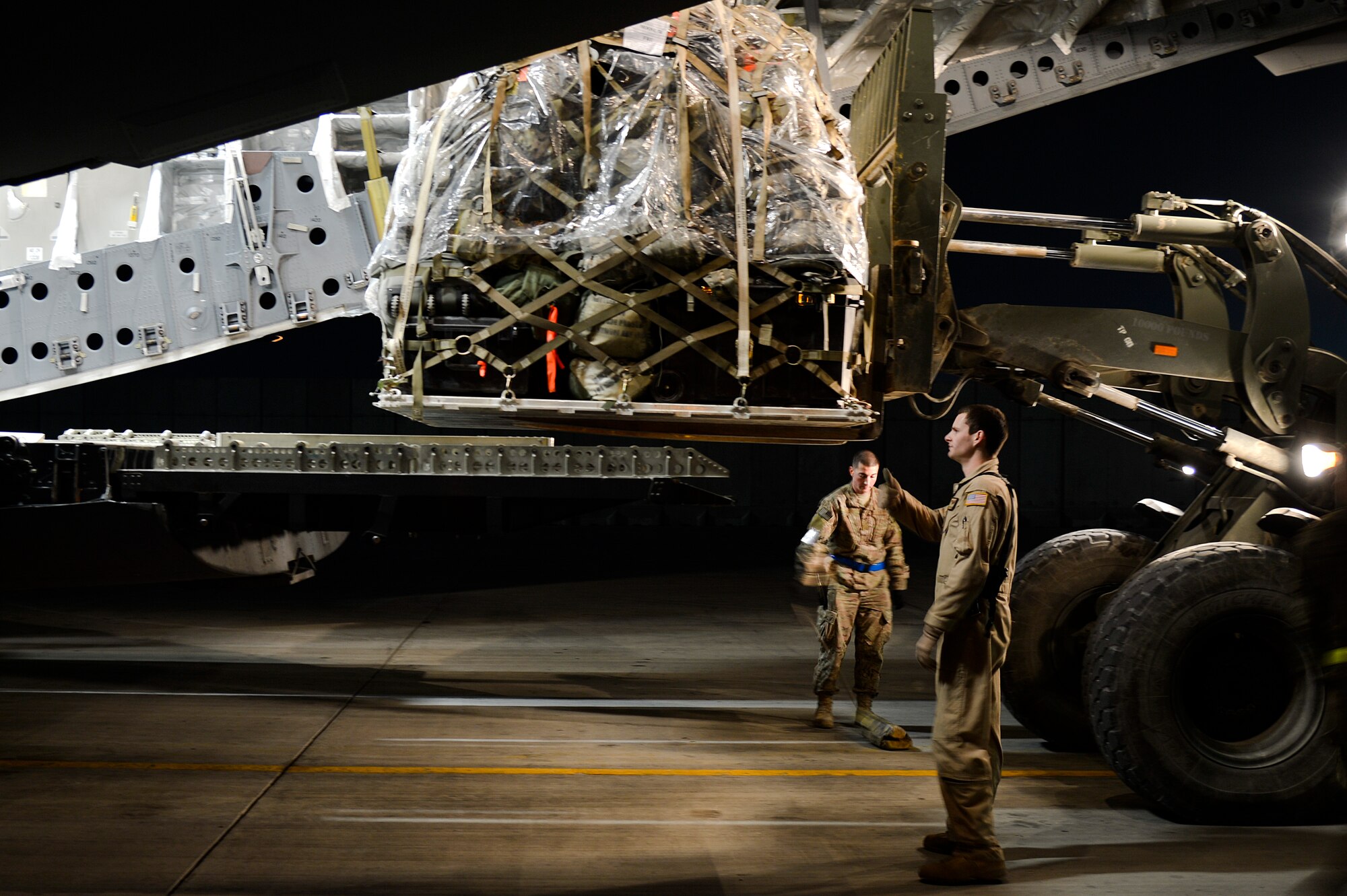U.S. Air Force Airmen load cargo pallets onto a C-17 Globemaster III at Bagram Airfield, Afghanistan, Feb. 10, 2014. The C-17, deployed from Joint Base Lewis-McChord, Wash., had two pallets of baggage loaded. (U.S. Air Force photo by Senior Airman Kayla Newman/Released)