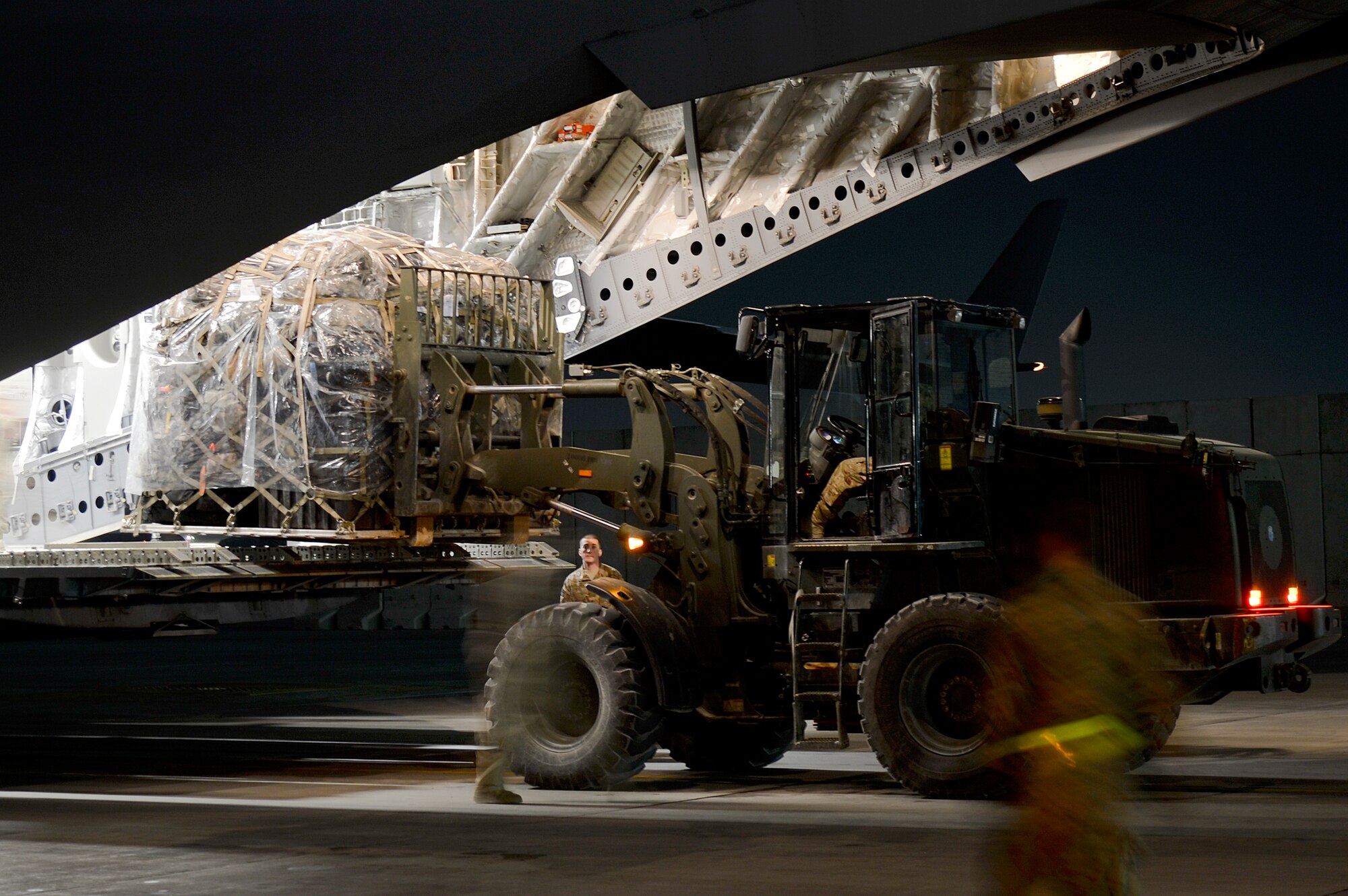 U.S. Air Force Airmen load cargo pallets onto a C-17 Globemaster III at Bagram Airfield, Afghanistan, Feb. 10, 2014. The C-17 is deployed from Joint Base Lewis-McChord, Wash.  (U.S. Air Force photo by Senior Airman Kayla Newman/Released)