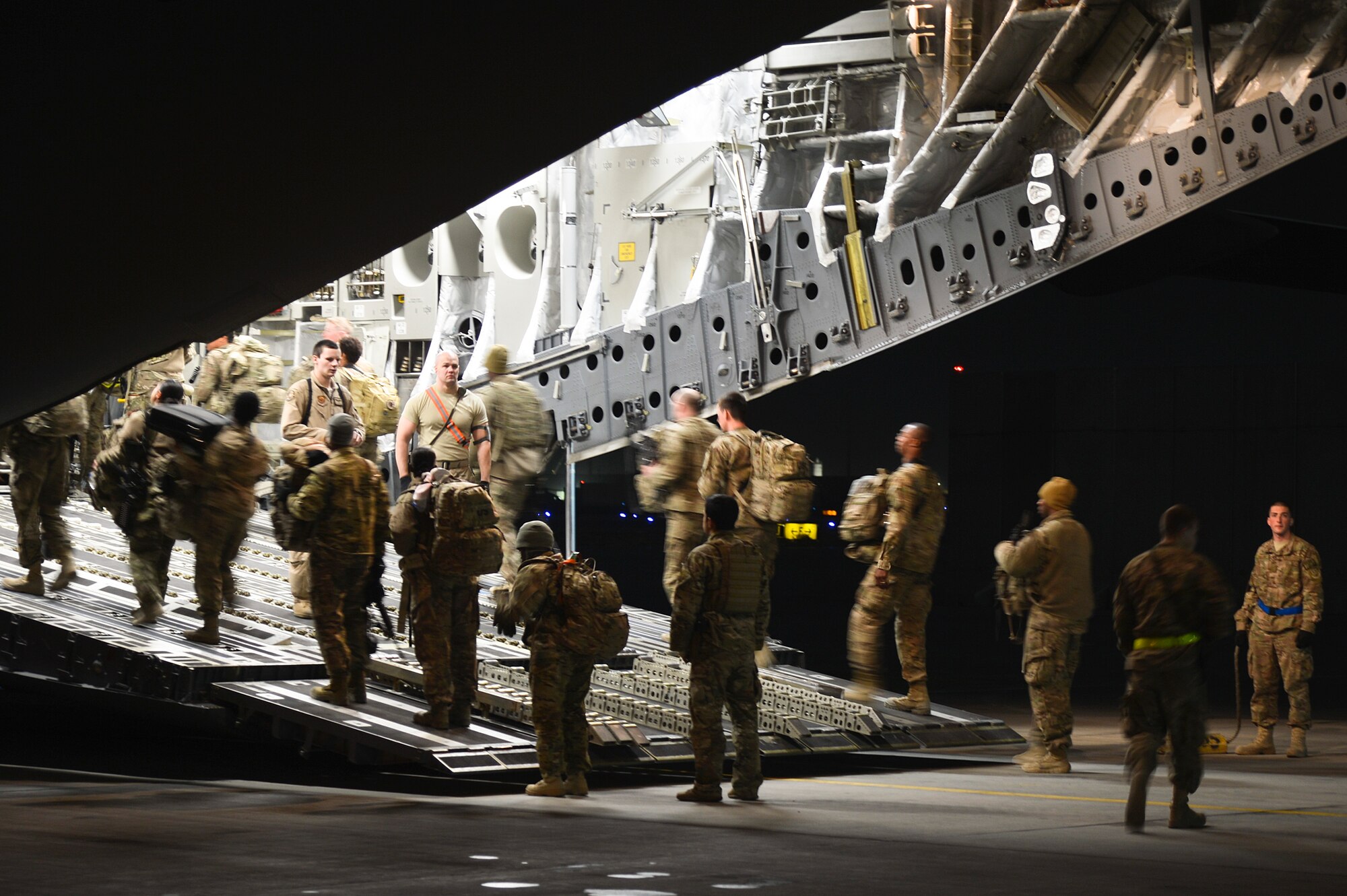 Service members board a C-17 Globemaster III at Bagram Airfield, Afghanistan, Feb. 10, 2014. After loading passengers, aerial port personnel loaded two baggage pallets. (U.S. Air Force photo by Senior Airman Kayla Newman/Released)