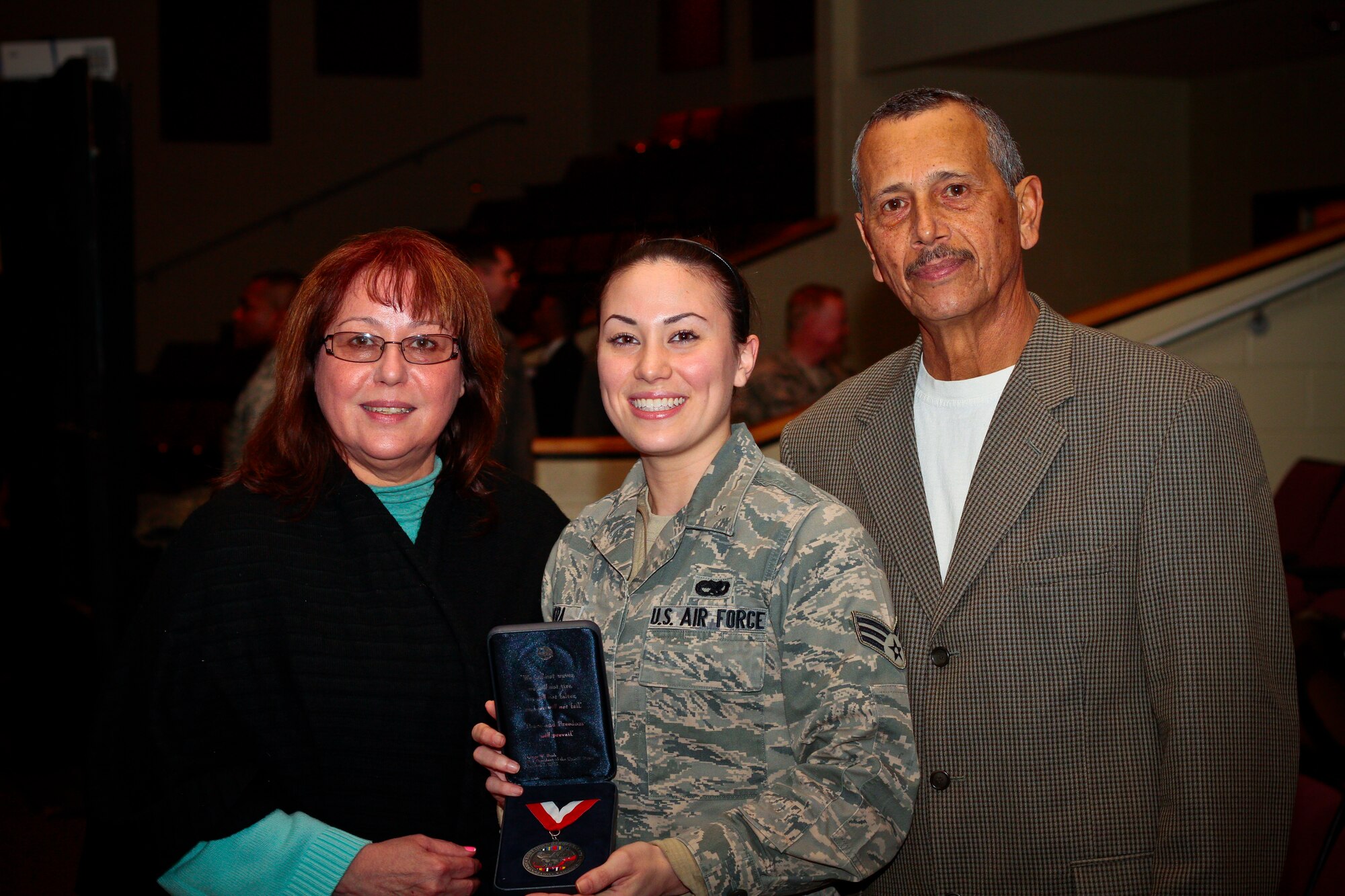 A picture of U.S. Air Force Senior Airman Monica Rivera presenting her mother Diana with a "center of influence" award.