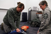 PETERSON AIR FORCE BASE, Colo. – Senior Master Sgt. Linda Armstrong, quality assurance superintendent for the 302nd Maintenance Group, right, watches Staff Sgt. Jessica Thomas, knowledge operations manager, 731st Airlift Squadron, as she performs CPR on a mannequin during her certification. Armstrong was one of three CPR instructors who trained and certified nearly 20 Reservists during the February Unit Training Assembly. (U.S. Air Force photo/Staff Sgt. Nathan Federico)