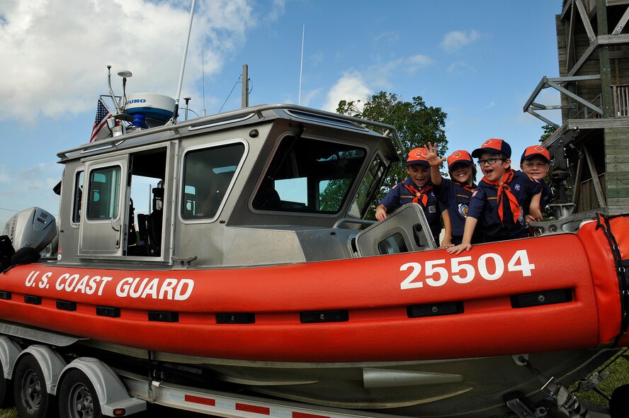 Tiger Cub Scouts from Pack 69, Homestead, Fla., explore a Defender Class 25’ boat assigned to the U.S. Coast Guard Maritime Safety and Security Team Miami as part of a tour of Homestead Air Reserve Base, Fla., on Jan 29. (U.S. Air Force photo/Tim Norton)