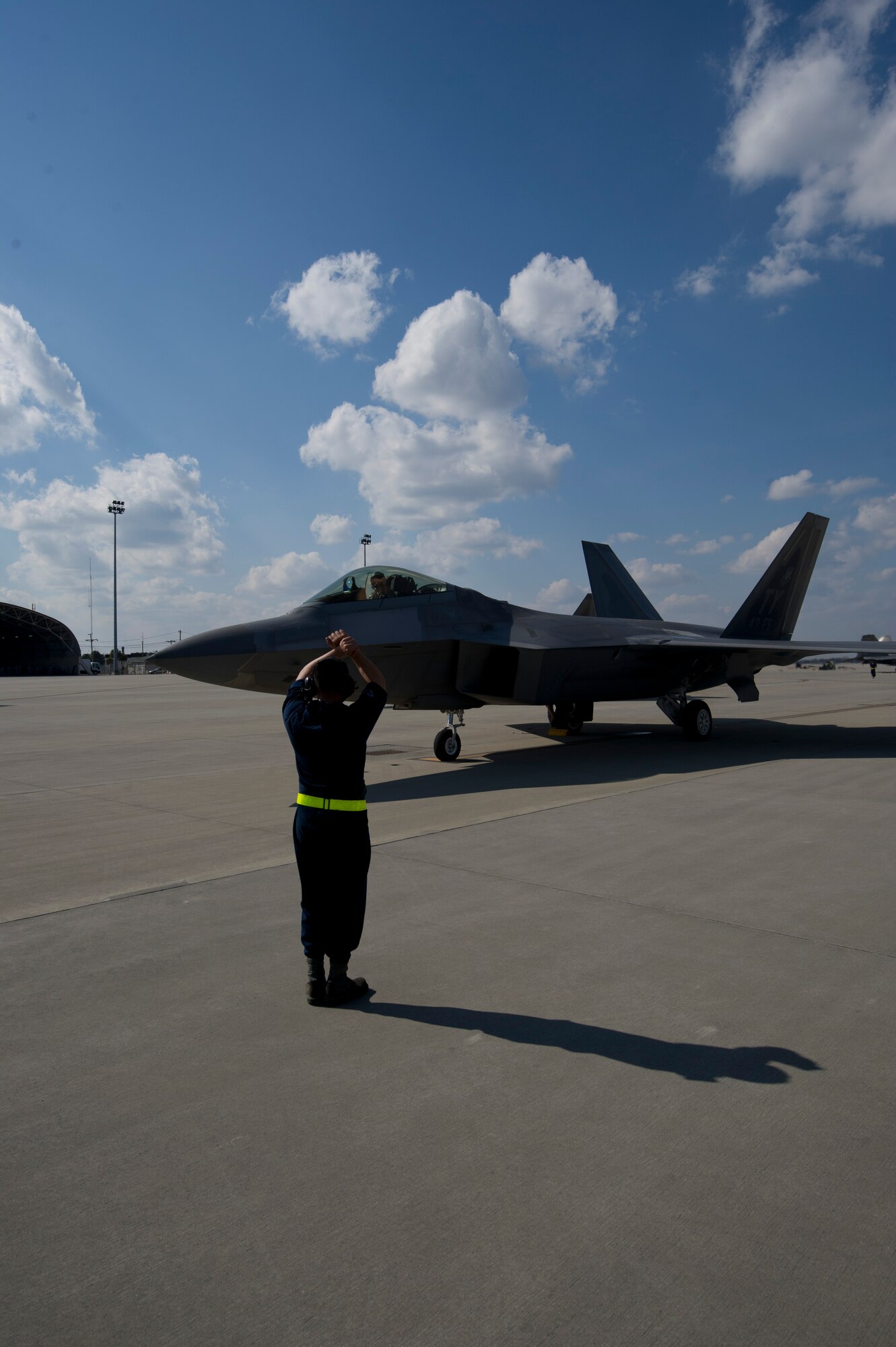 Senior Airman William Trisch, 43rd Aircraft Maintenance Unit crew chief, marshals an F-22 Raptor prior to take-off Feb. 10 at the Savannah Combat Readiness Training Center, 165th Airlift Wing, Savannah Air National Guard, Ga. Tyndall deployed more than 200 members and 14 F-22s to Savannah for Sentry Savannah 2014, a joint-force deployment exercise. (U.S. Air Force photo by Senior Airman Christopher Reel)