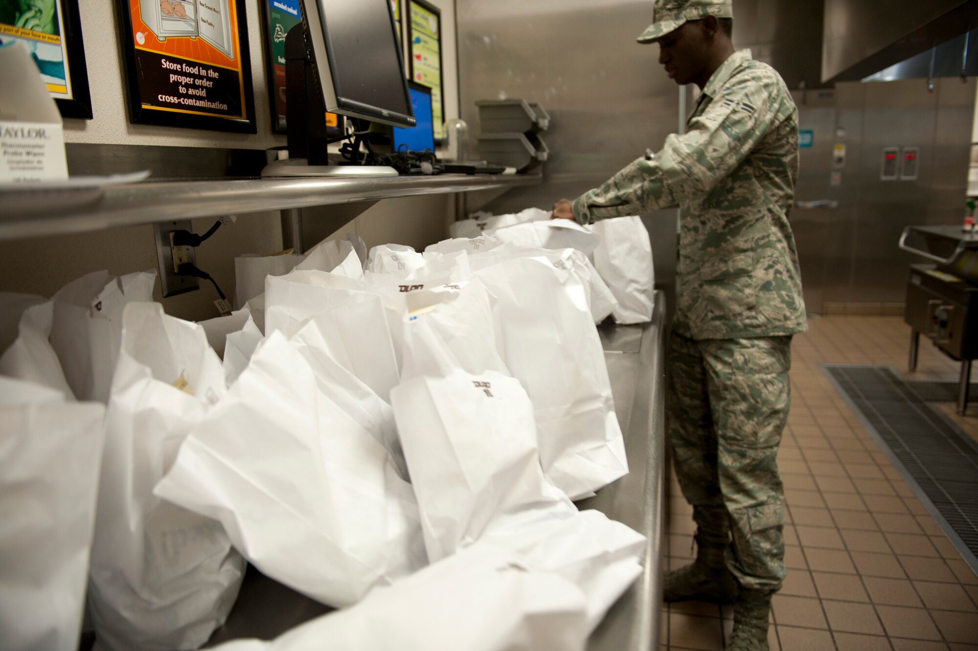 Airman 1st Class Cheikh Dieng, 1st Special Operations Force Support Squadron food service apprentice, prepares flight meals for Airmen at the Riptide Dining Facility on Hurlburt Field, Fla., Feb. 6, 2014. The flight kitchen provides meals for Hurlburt personnel who work on the flightline. (U.S. Air Force photo/Senior Airman Krystal M. Garrett)