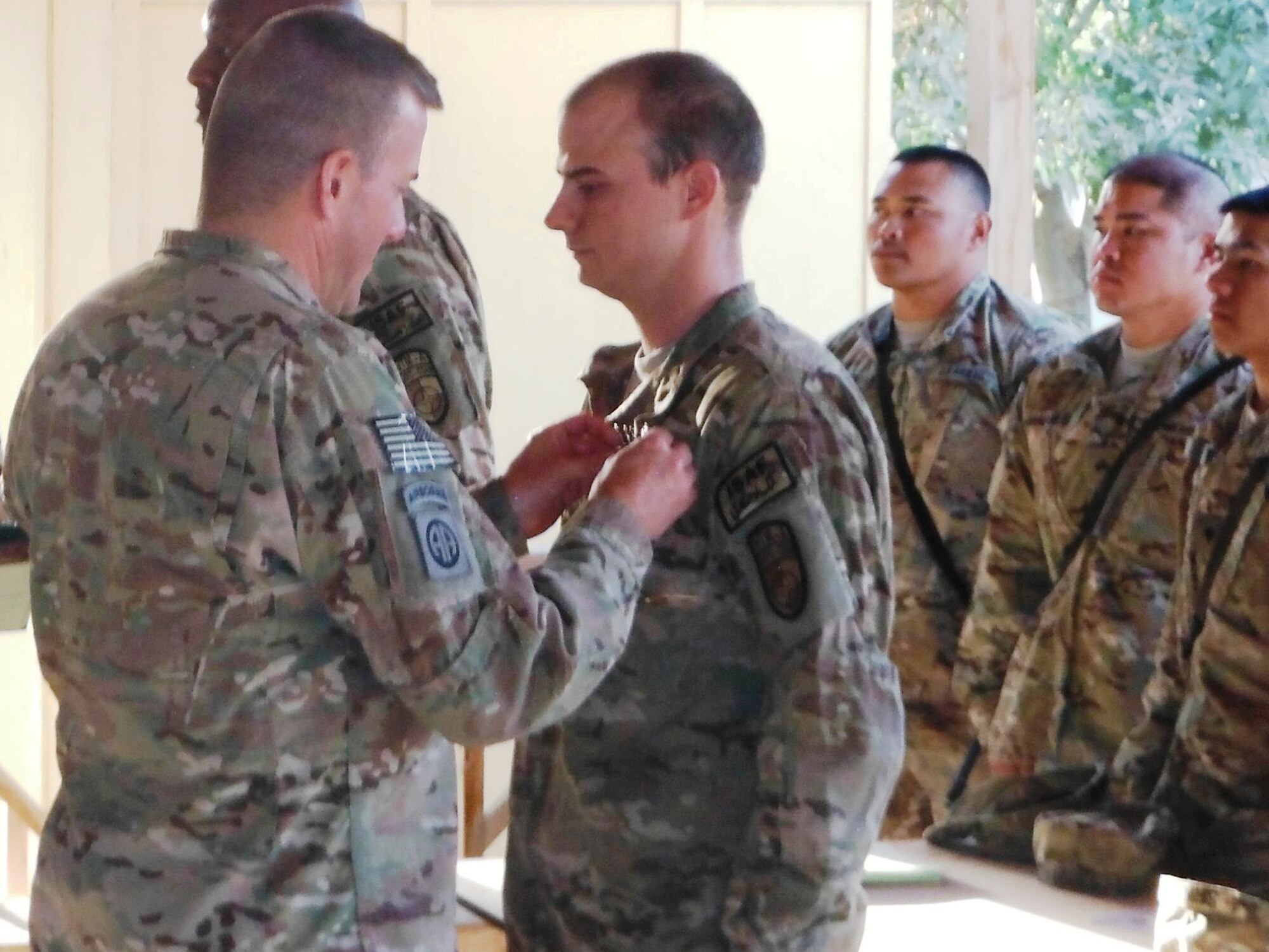 Army Col.Walter S Sweetser pins a Bronze Star medal on Senior Airmen Jeremy Lowe, 325th Communications Squadron communications and antenna systems journeyman, during his recent deployment to Afghanistan in support of Operation ENDURING FREEDOM. (U.S. Air Force courtesy photo)