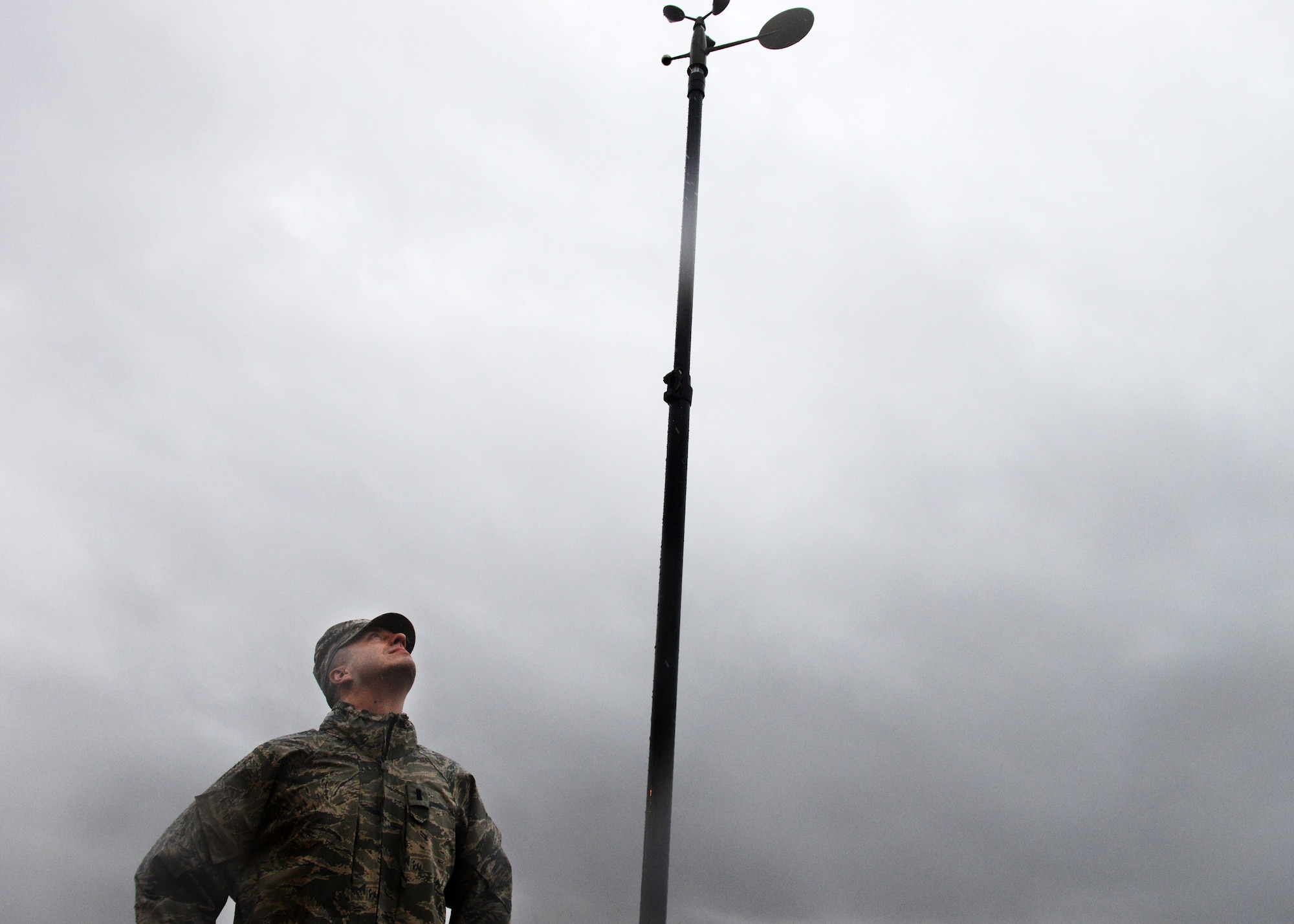 First Lieutenant  David DeMeuse, 31st Operations Support Squadron Weather Flight commander, observes a TMQ-53 automated observing weather station during a rainstorm, Jan. 30, 2014, at Aviano Air Base, Italy. The weather station automatically takes readings and processes them through a computer, which provides weather technicians more time to analyze weather data. (U.S. Air Force photo/Airman 1st Class Ryan Conroy) 