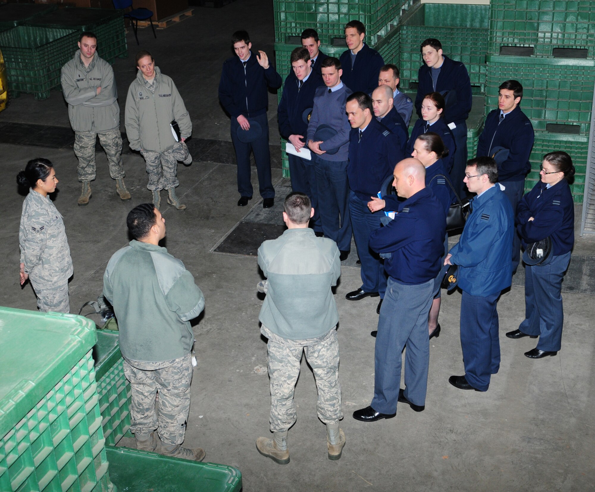 Members of the 100th Logistics Readiness Squadron, left, brief RAF officer students, instructors and leadership from RAF Halton and RAF High Wycombe, both in Buckinghamshire, Feb. 5, 2014, in the supply warehouse on RAF Mildenhall, England. The RAF officers spent the day visiting various units within the 100th LRS, including the personnel deployment function, aircraft parts store, special purpose vehicle maintenance and the cargo deployment function.  The visit served to strengthen relationships and build partnerships between the two nations' air forces and provided an insight into the similarities and differences in how both work. (U.S. Air Force photo by Karen Abeyasekere/Released)