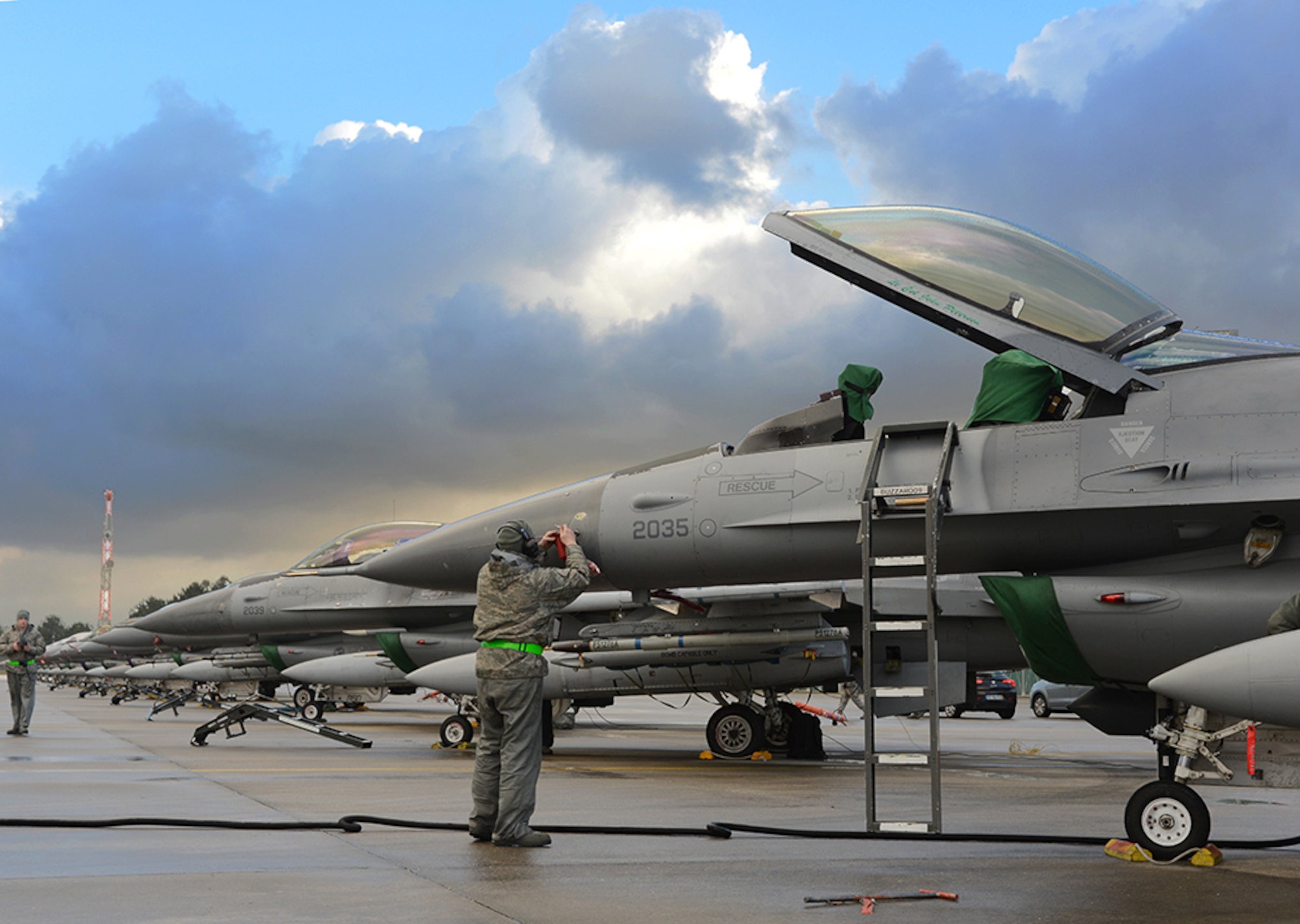 A maintainer preps an F-16 Fighting Falcon on Feb. 10, 2014, following an Atlantic storm that hit the surrounding area Feb. 9, 2014. Fourteen F-16 Fighting Falcons from the 31st Fighter Wing were lined up on the Monte Real Air Base flightline to protect them from storm debris. (U.S. Air Force photo/2nd Lt. Allie Delury)