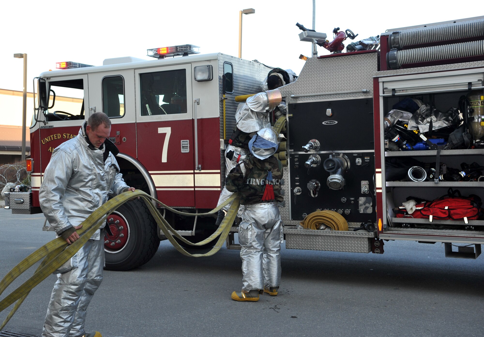 Firefighters from the 51st Civil Engineer Squadron Fire Department fold and stow a fire hose outside Bldg. 949 at the conclusion of a mock structure fire and bug-out scenario during Operational Readiness Exercise Beverly Midnight 14-02 at Osan Air Base, Republic of Korea, Feb. 11, 2014. Emergency responders that can be ready to go at a moment’s notice are critical to ensuring the safety of base personnel in times of peace and during wartime contingency operations. (U.S. Air Force photo/Airman 1st Class Ashley J. Thum)