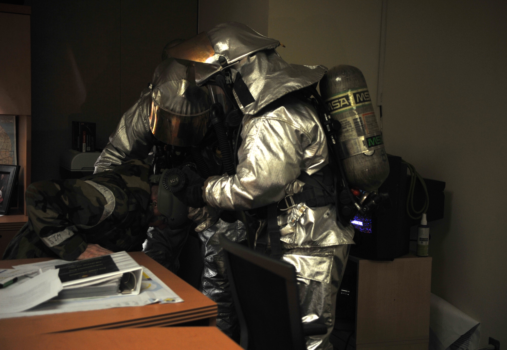 Firefighters from the 51st Civil Engineer Squadron Fire Department help a mock victim to his feet as part of a mock structure fire and bug-out scenario in Bldg. 949 during Operational Readiness Exercise Beverly Midnight 14-02 at Osan Air Base, Republic of Korea, Feb. 11, 2014. The firefighters assessed the role player’s condition while escorting him to safety. (U.S. Air Force photo/Airman 1st Class Ashley J. Thum)