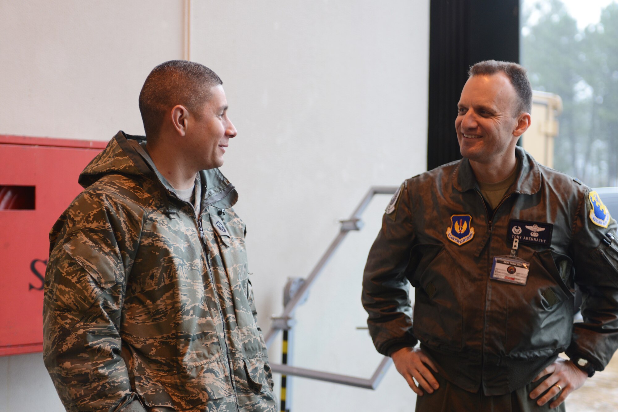 Master Sgt. Noe Chavez, 31st Aircraft Maintenance Squadron first sergeant, briefly chats with Col. Anthony Abernathy, 31st Operations Group commander Feb. 11, 2014 in a maintenance hangar at Monte Real Air Base, Portugal. For many maintainers, Real Thaw 14 is the first opportunity to work alongside other NATO countries outside the walls of Aviano Air Base. (U.S. Air Force photo/2nd Lt. Allie Delury).