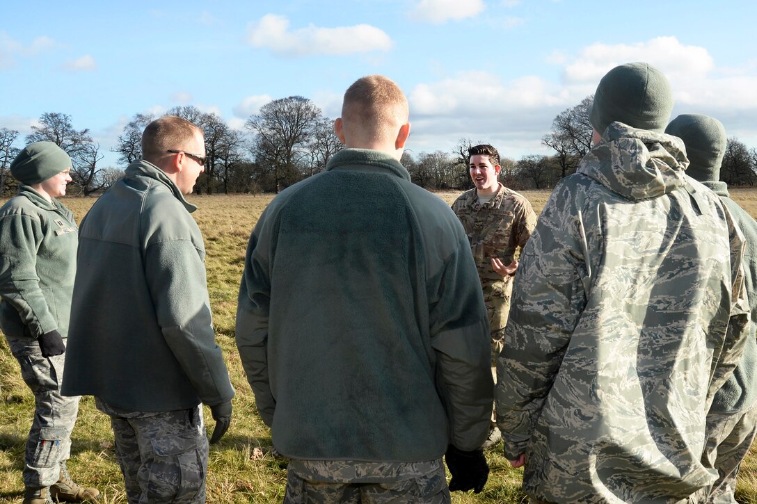 U.S. Air Force Senior Airman Kyle Hicks, center, briefs airmen who will play mock victims on Stanford Training Area, England, Feb. 6, 2014. Hicks, an independent duty medical technician, is assigned to the 56th Rescue Squadron. The airmen participated in four days of training to support the Air Force's combat search and rescue mission.