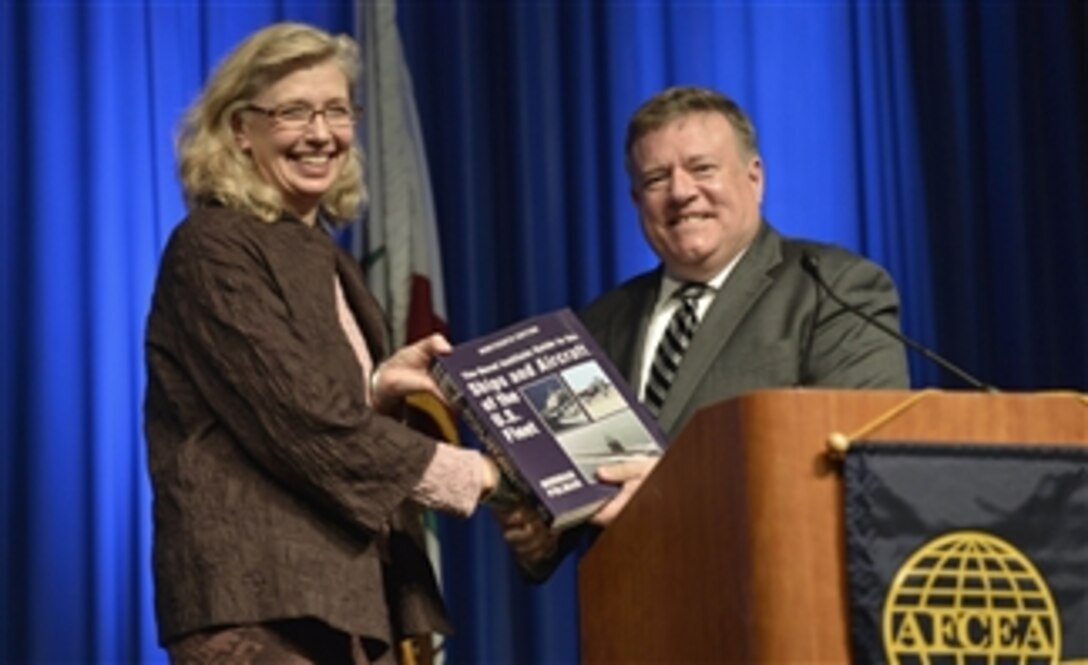 Acting Deputy Defense Secretary Christine H. Fox receives the book, "Ships and Aircraft of the U.S. Fleet," from retired Navy Vice Adm. Peter H. Daly after making remarks at the Western Conference and Exposition in San Diego, Feb. 11, 2014. The conference is the largest event of its kind on the West Coast for sea services and supporting contractors.


