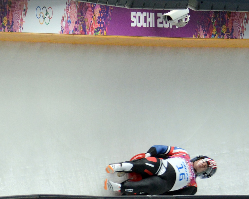 Army World Class Athlete Program Sgt. Matthew Mortensen (on top) and Sgt. Preston Griffall (steering on bottom) round a curve in their first run of Olympic luge doubles at Sanki Sliding Center Feb. 12, 2014. They finished their second run with a combined time of 1:41:703 to end up in 14th place.