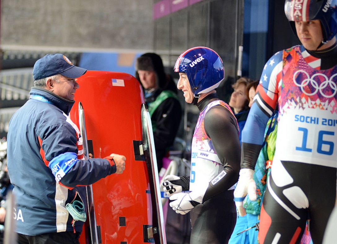 U.S. Army World Class Athlete Program and Team USA luge coach Staff Sgt. Bill Tavares (left) provides last-minute instructions before handing the sled to WCAP Sgt. Preston Griffall (center) and Sgt. Matt Mortensen (right) for their first heat of the Olympic luge doubles event Feb. 12 at Sanki Sliding Centre in Krasnaya Polyana, Russia. Mortensen and Griffall finished 14th with a two-run cumulative time of 1 minute, 41.703 seconds. The German duo of Tobias Wendl and Tobias Arlt won the gold medal with a winning time of 1:38.933, followed by silver medalists Andreas Linger and Wolfgang Linger of Austria (1:39.455) and bronze medalists Andris Sics and Juris Sics of Latvia (1:39.790). (U.S. Army photo by Tim Hipps, IMCOM Public Affairs)