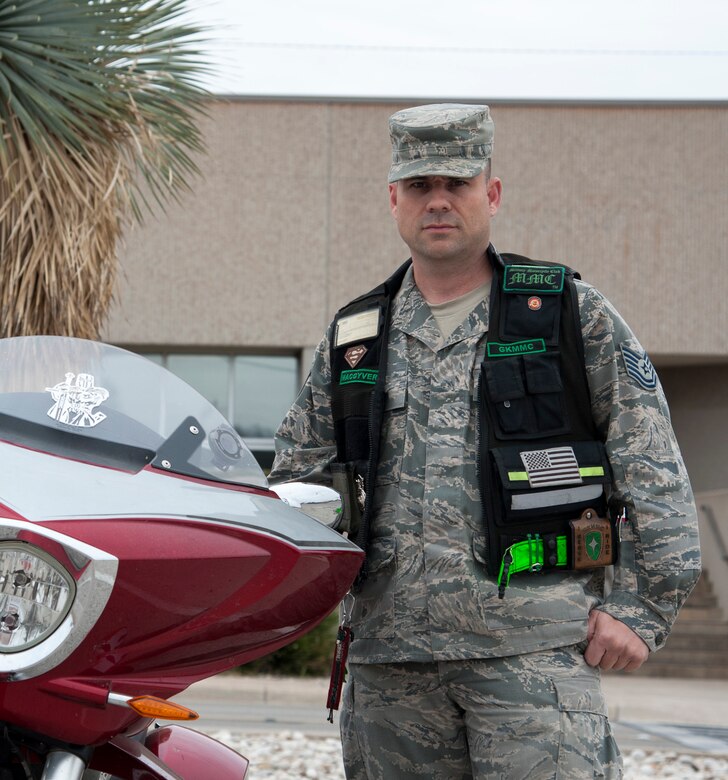 Tech. Sgt. Shane Buss, 47th Flying Training Wing Equal Opportunity acting director and member of the Green Knights, poses for a photo by his motorcycle on Laughlin Air Force Base, Texas, Feb. 5, 2013. Buss played a major role in the rescue of two injured persons after a crash near Bracketville. (U.S. Air Force photo/Airman 1st Class Jimmie D. Pike)